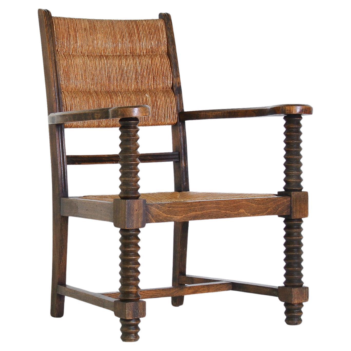 A 1950s Oak Corkscrew Armchair with Straw Seat attributed to Charles Dudouyt