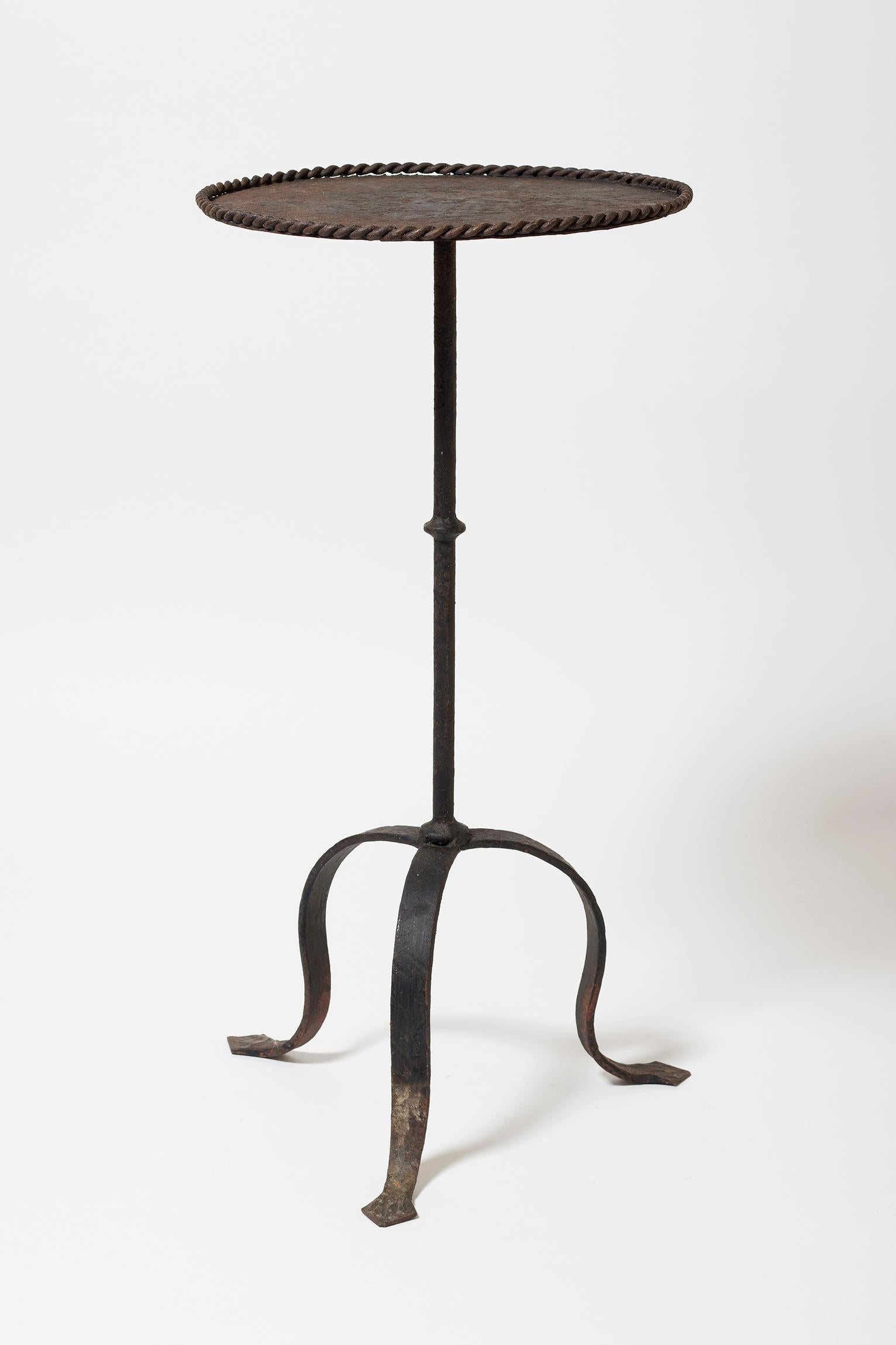 A black wrought iron martini table, with a twisted rop edge
Spain, 1950s.