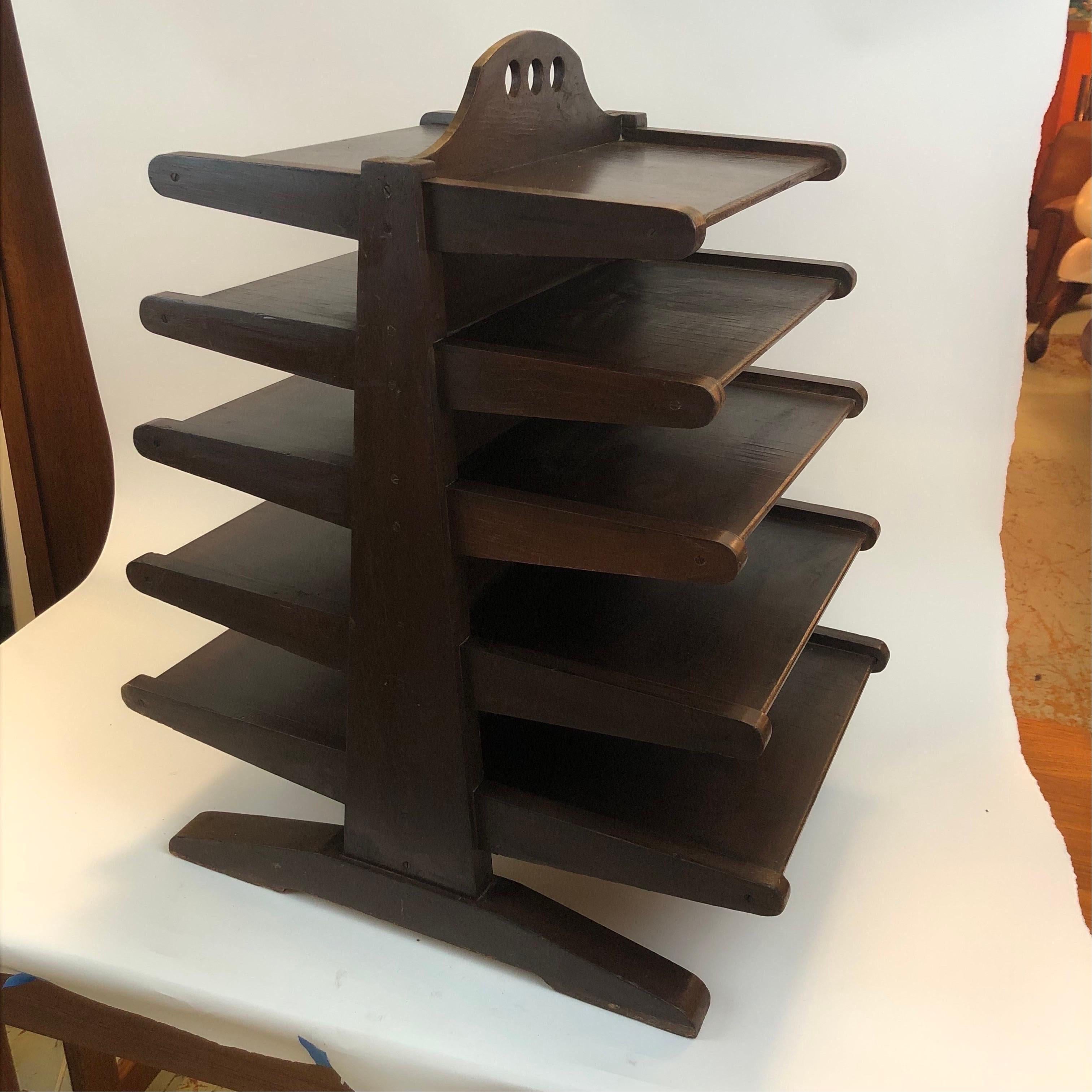 An of the period five tier DIY Dunbar Magazine tree in rustic original dark walnut stained wax finish, and taking heavy cues from the highly sought after Edward Wormley piece in similar form. Carpenters editorial decisions of note include a wide