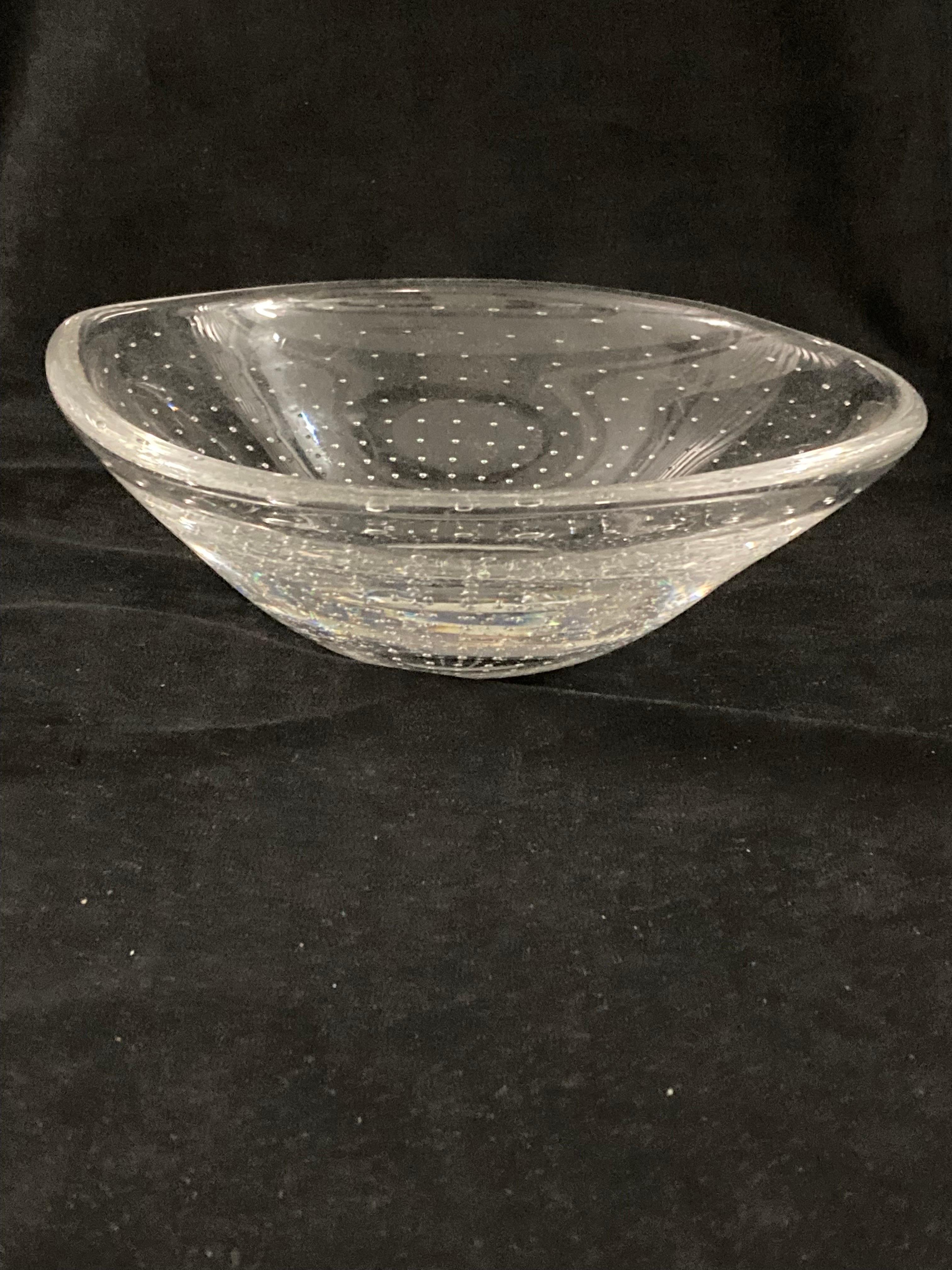 A 1950s Swedish clear glass with air bubbles bowl by Vicke Lindstrand for Kosta.

Made from hand-blown glass with air bubbles. The bowl has an undulating rim, which is not perfectly symmetrical and gives it a more natural handmade appearance.

The