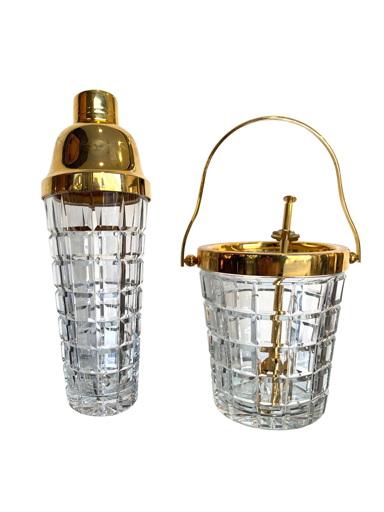 A stunning Val St Lambert crystal cocktail shaker and matching ice bucket with faceted block crystal design and gold plated rims and lid, with a set of gold plated ice grabbers for the ice bucket.