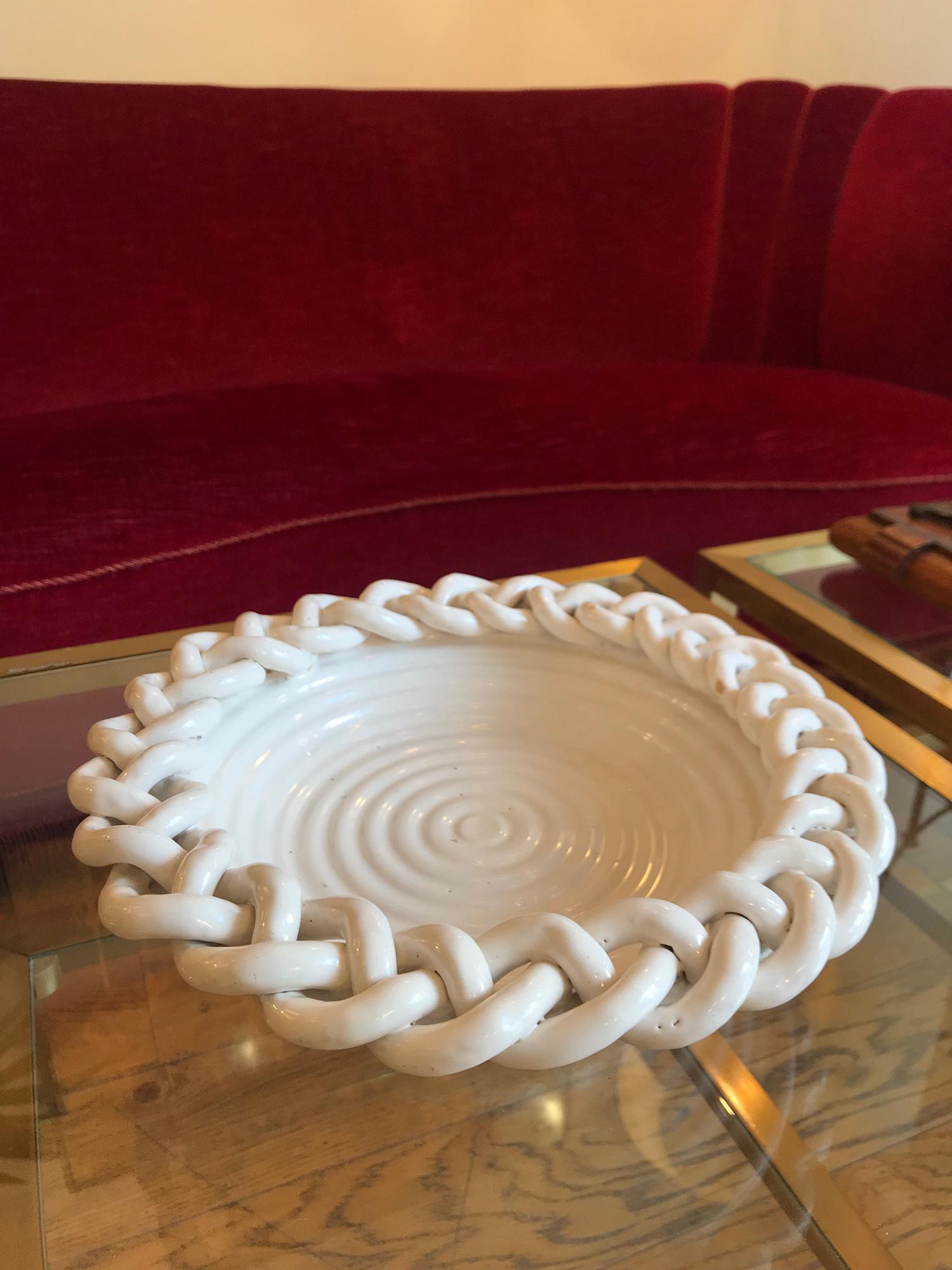 A large white glazed ceramic large bowl, with a braided border
Vallauris, France, circa 1955
monogrammed to the underside.