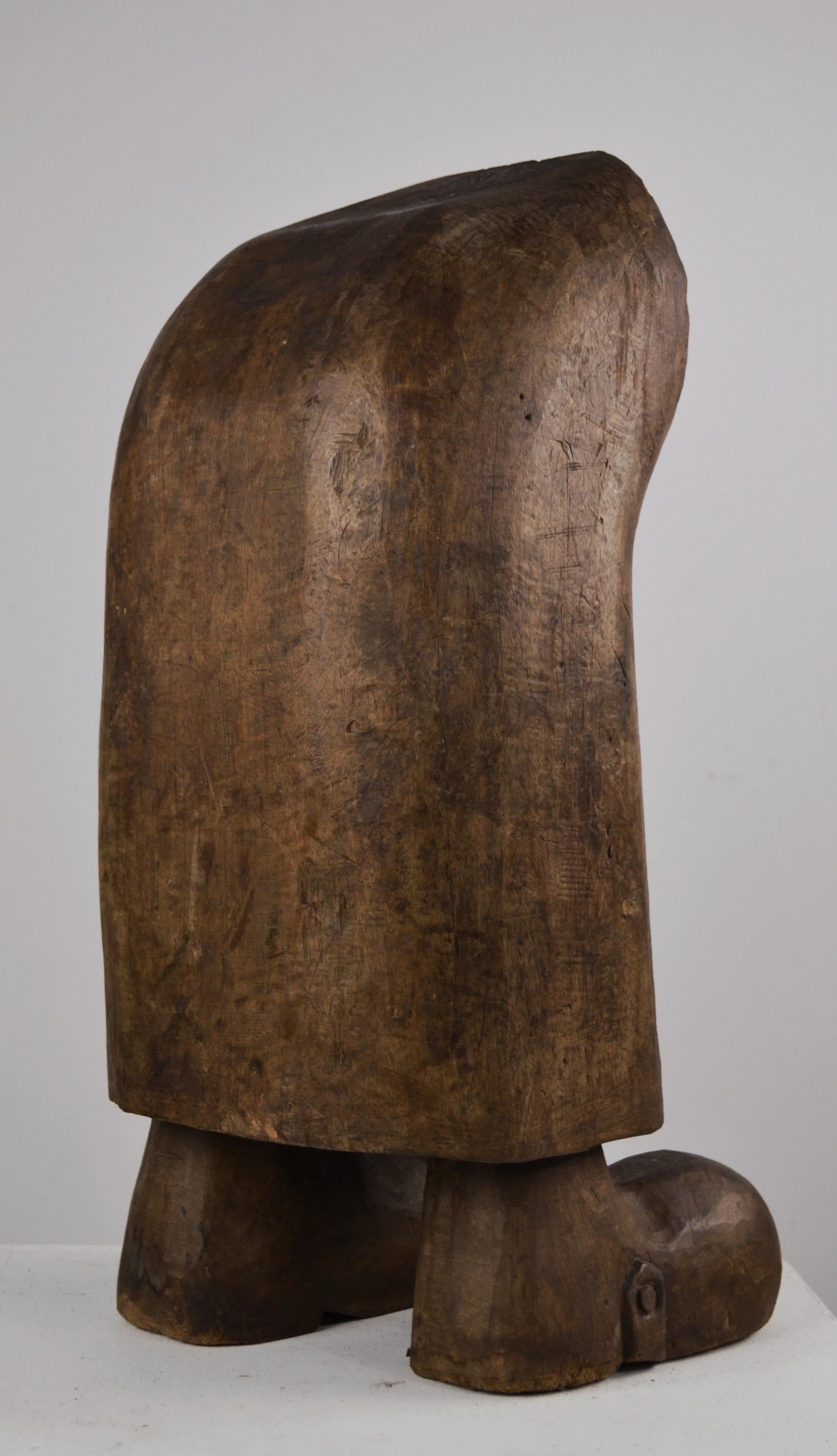 An exceptional and unique sculpture crafted from a single block of solid wood (monoxylous), dating from the 1950s. It depicts an abstract figure where only the shoes are distinguishable. Its naïve style and beautiful original patina give it a