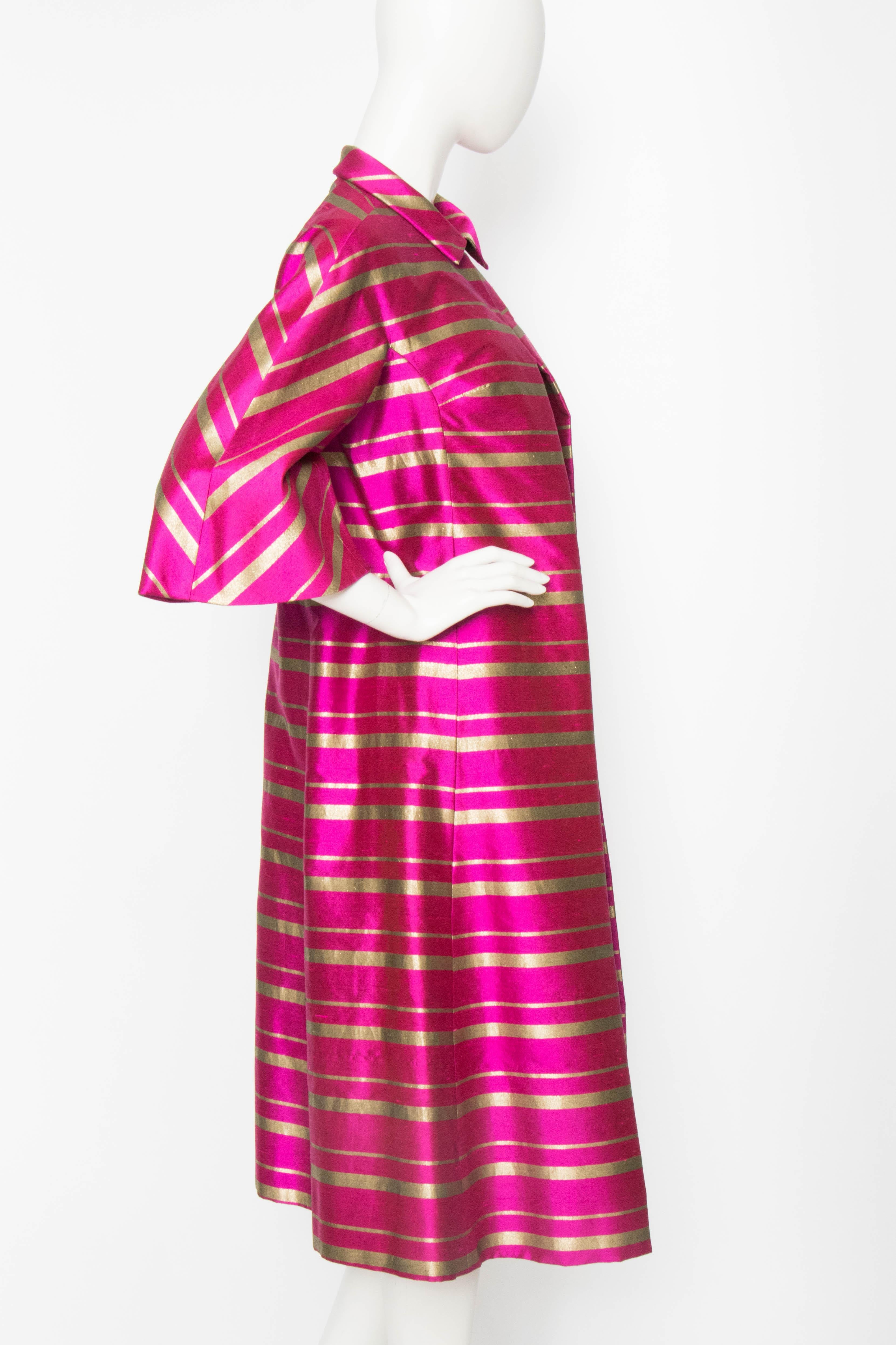 An incredible 1960s Jean Voigt pink silk jacket with gold lurex detailing. The coat has an open front and a single hook & eye closure at the collar. The coat is fully lined in matching pink silk. 

The size of the coat corresponds to a modern size