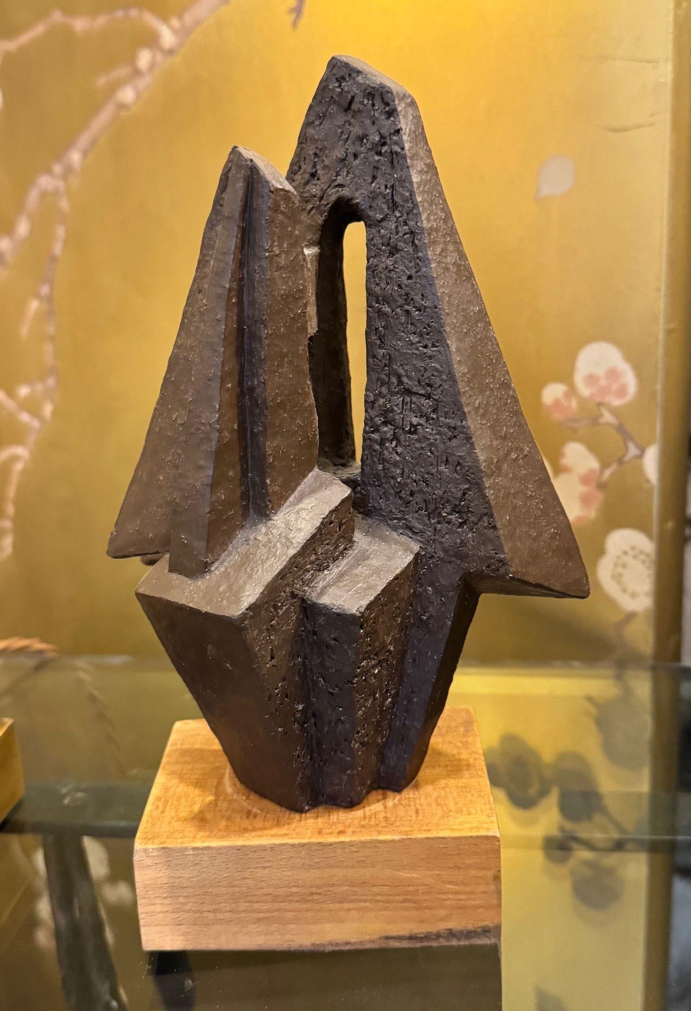 A 1960s Belgian ceramic abstract sculpture with bronze textured style finish mounted on natural wooden base, signed on the base 