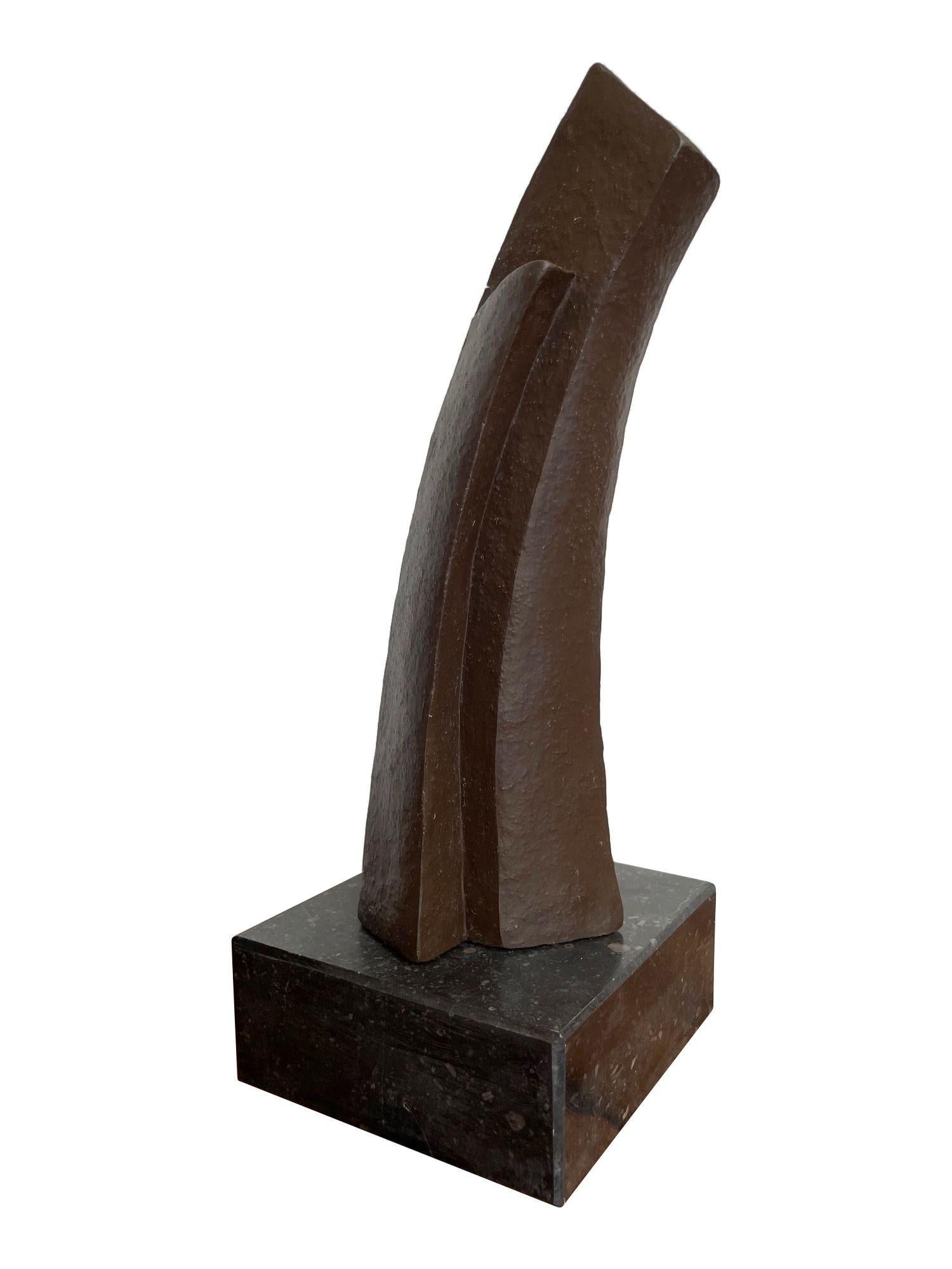 A 1960s Belgian ceramic abstract sculpture with bronze textured style finish mounted on black marble base, signed on the base 