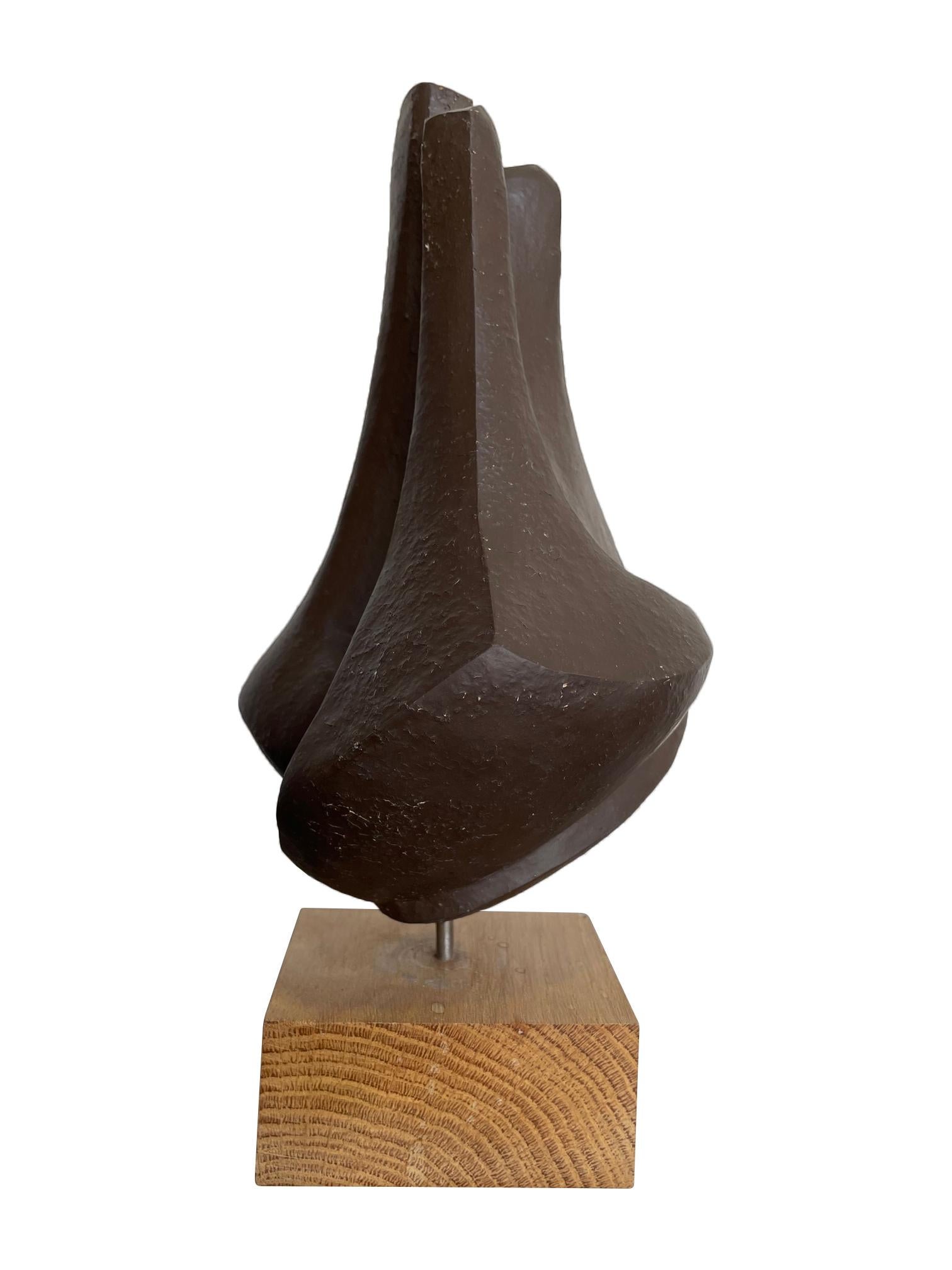 A 1960s Belgian ceramic abstract sculpture with bronze textured style finish mounted on natural wooden base, signed on the base 