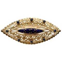 A 1960s Blue Enamel, Sapphire & Gold Brooch