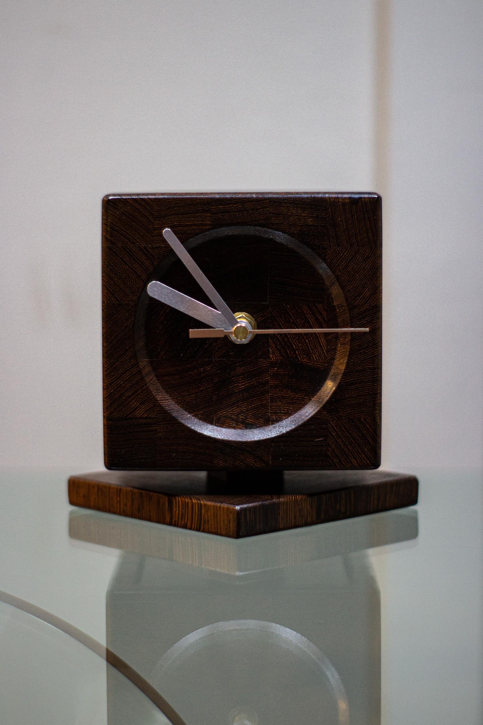 A 1960s clock by Danish maker Lysgaard Mobler, the clock is made of a tropical hard wood very similar to rosewood. 

The clock has a new movement put in it and is battery operated. 

The clock can be rotated 360 degrees on the base.