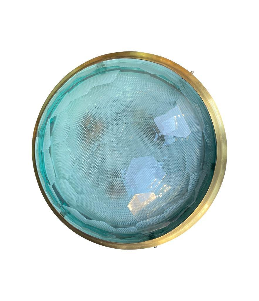 A 1960s large Italian flush mount ceiling light by Pia Guidetti Grippa for Italian lighting company Lumi. The glass has a wonderful facetted profile similar to an insects compounnd eyes. It sits in a brass frame with a diffuser behind and there are