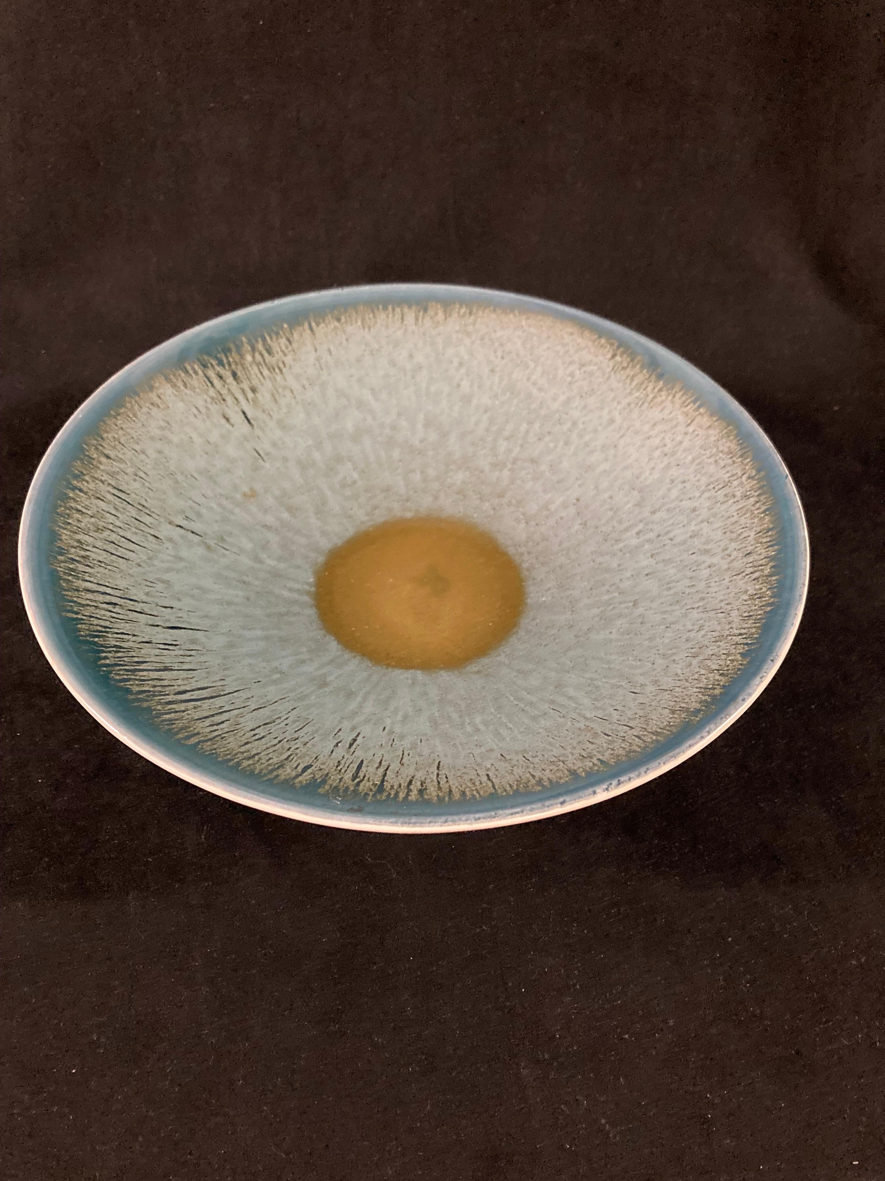 A 1960s Poole Pottery bowl or dish with abstract copper verdigris design.

Bears maker's mark under. This particular 'POOLE STUDIO england' mark was used from 1964 to 1966, allowing to date the bowl accurately.

It is a lovely decorative object in