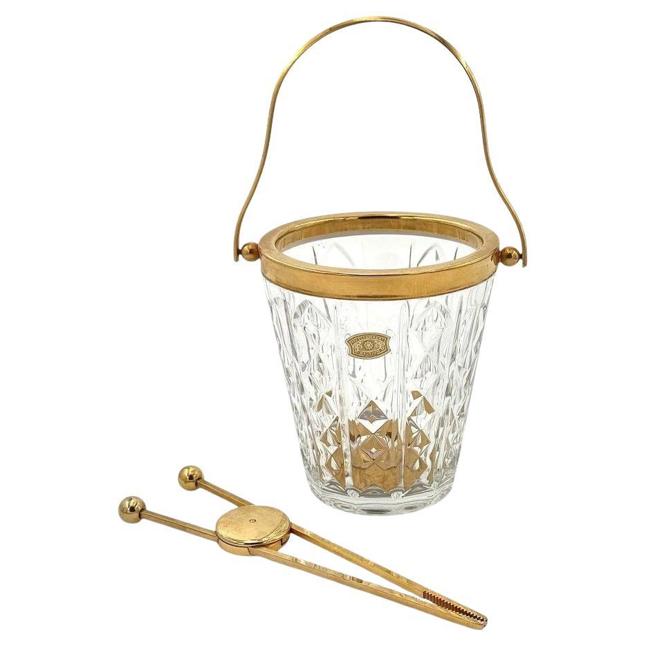 A 1960s Val Saint Lambert crystal and gold plated ice bucket with ice grabbers