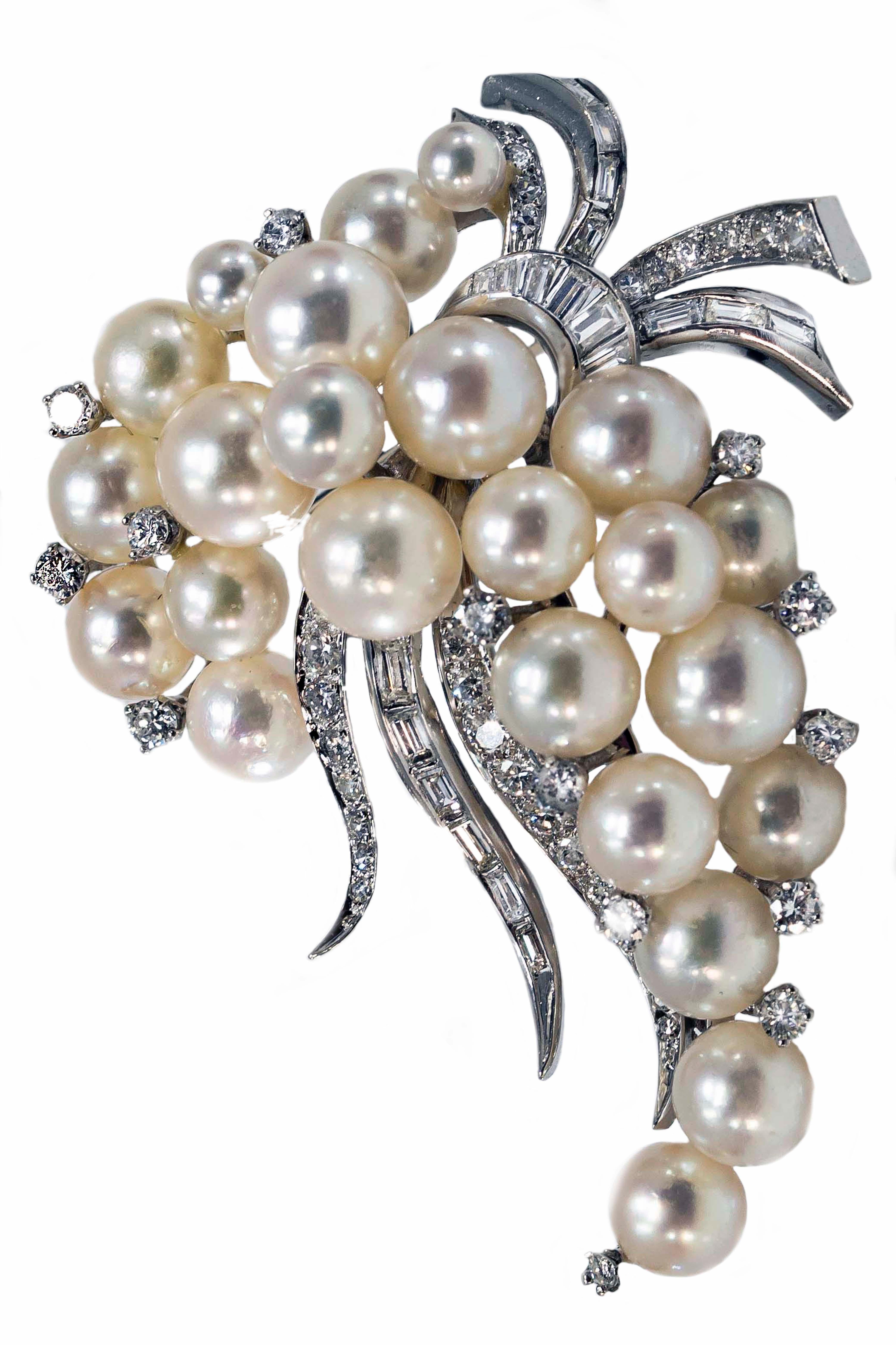 A White Gold Pearl and Diamond Set Pin Cornucopia, a symbol of plenty consisting of a goat's horn overflowing with flowers, fruit, and Corn 

65 diamonds weighing approximately 2.27 carats decorated with 24 pearls. 

Brooch Dimensions : 

225 mm x