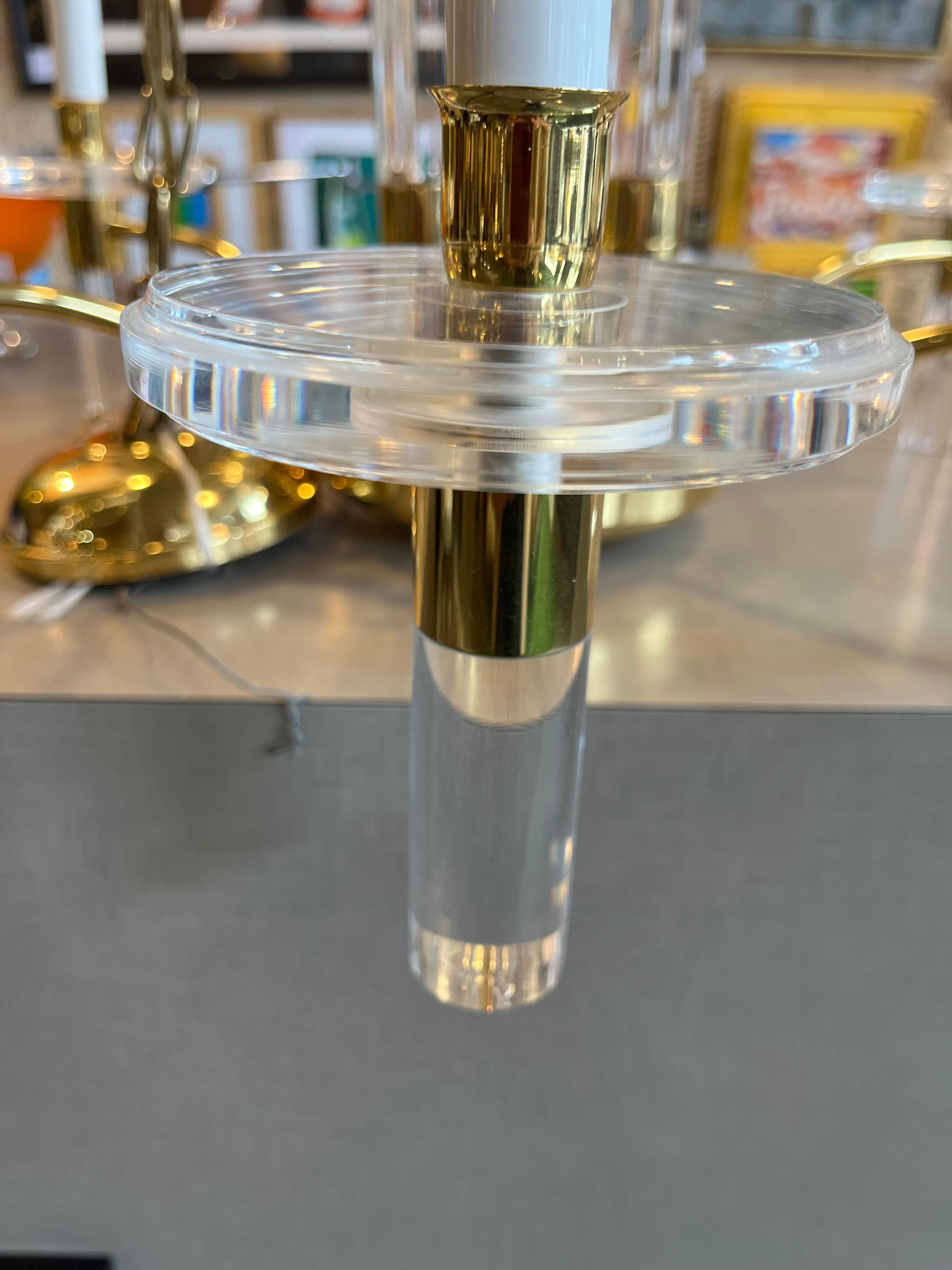 A six-arm Lucite and brass chandelier by Charles Hollis Jones.