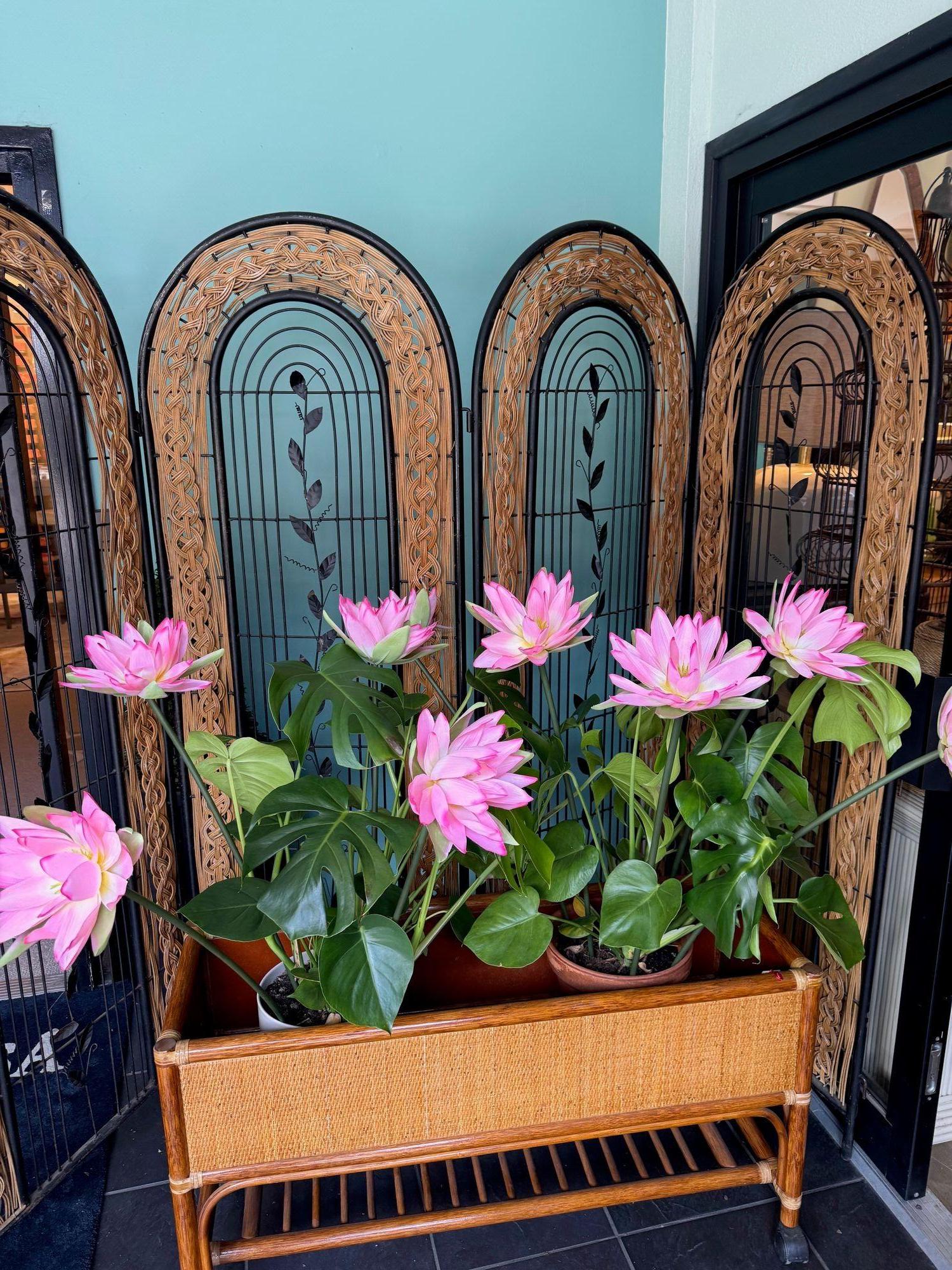 A 1970s French woven rattan and metal four panelled arched topped  room divider screen with leaf designs in the centre of each hinged panel