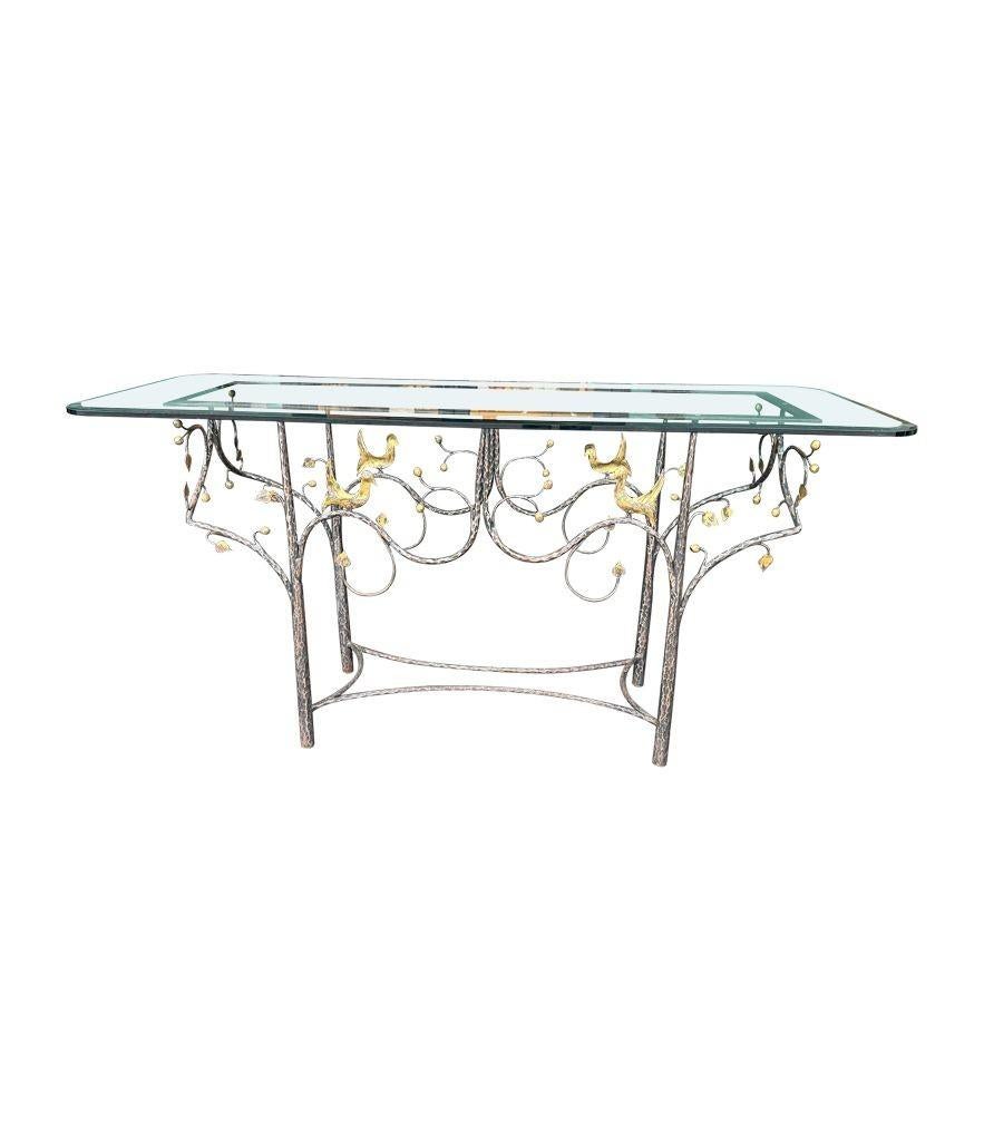 A 1970s unique handmade wrought iron console table with solid marble top. The base is hand forged with detailed organic tree design with gilt birds and leaves. Good quality one off piece. There is also a larger thick bevelled glass top 150cm wide x
