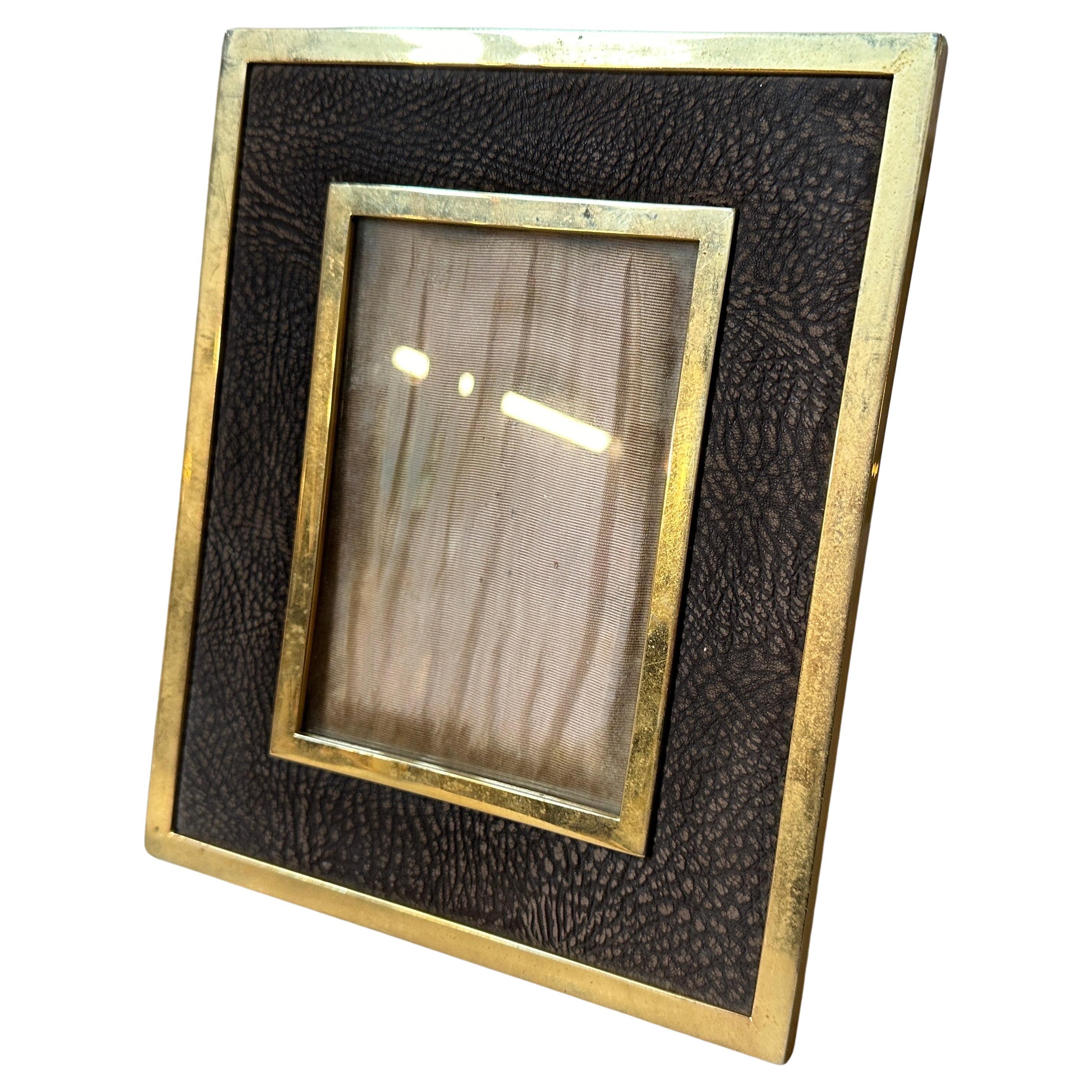 This Italian picture frame exudes elegance and sophistication. Crafted during the height of mid-century design, it showcases a perfect blend of luxurious materials and minimalist aesthetics. The frame boasts a sleek brass construction, a hallmark of