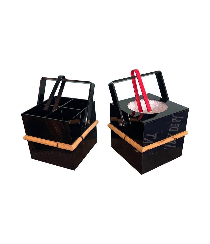 A 1970s Italian bar set comprising an ice bucket with lid and bottle holder in black perspex with bamboo handles and detailing. With two ice grabbers red and black