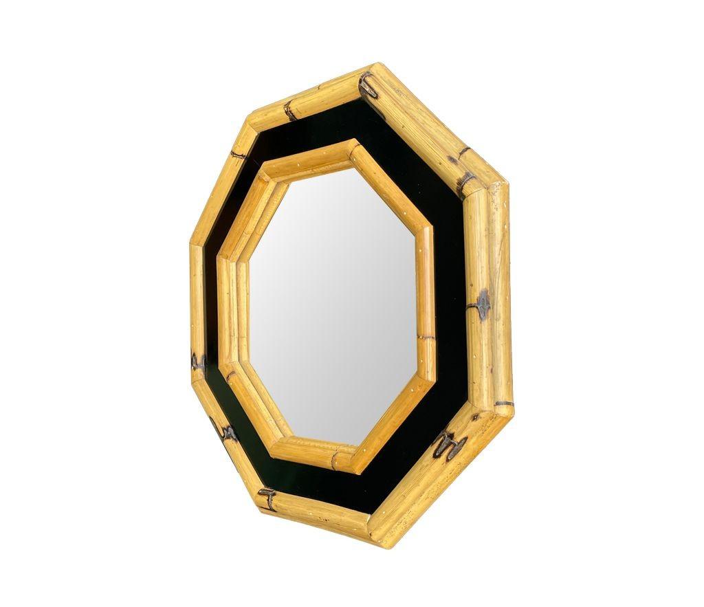 A 1970s Italian octagonal bamboo mirror with chunky bamboo frame with black laminated centre