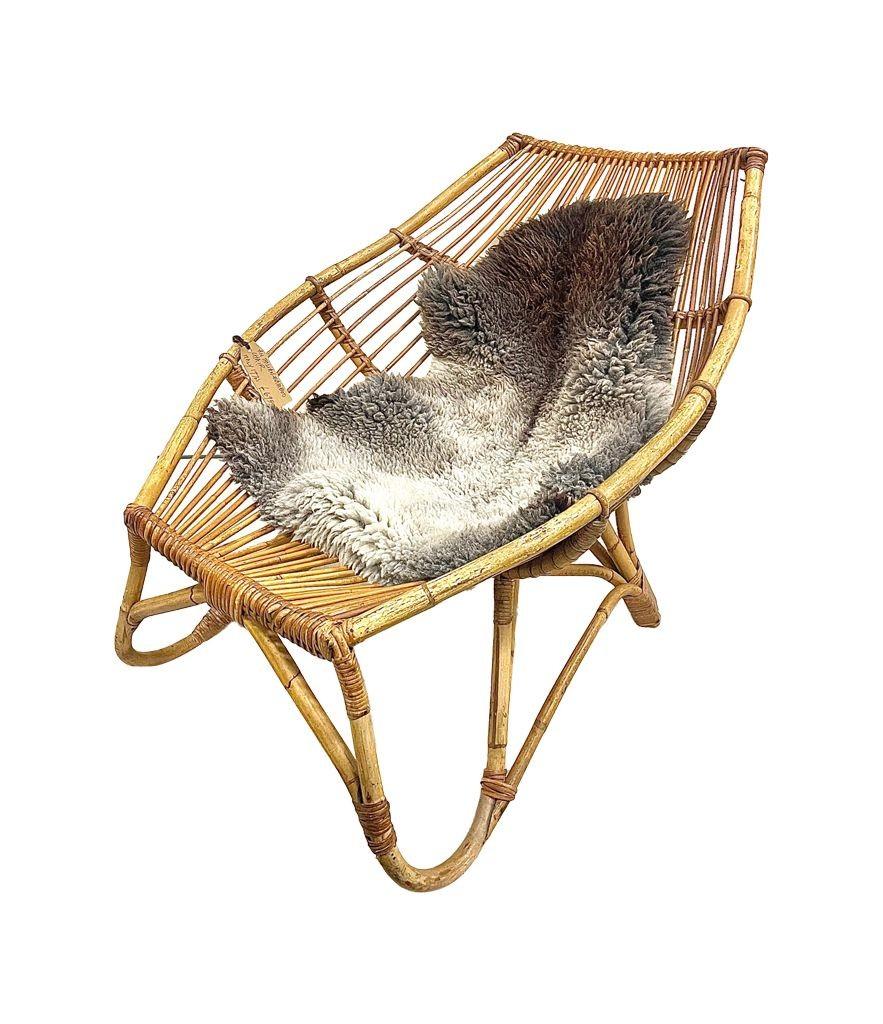 A 1970s Italian Riviera bamboo lounge chair in the style of Franco Albini with later sheepskin.