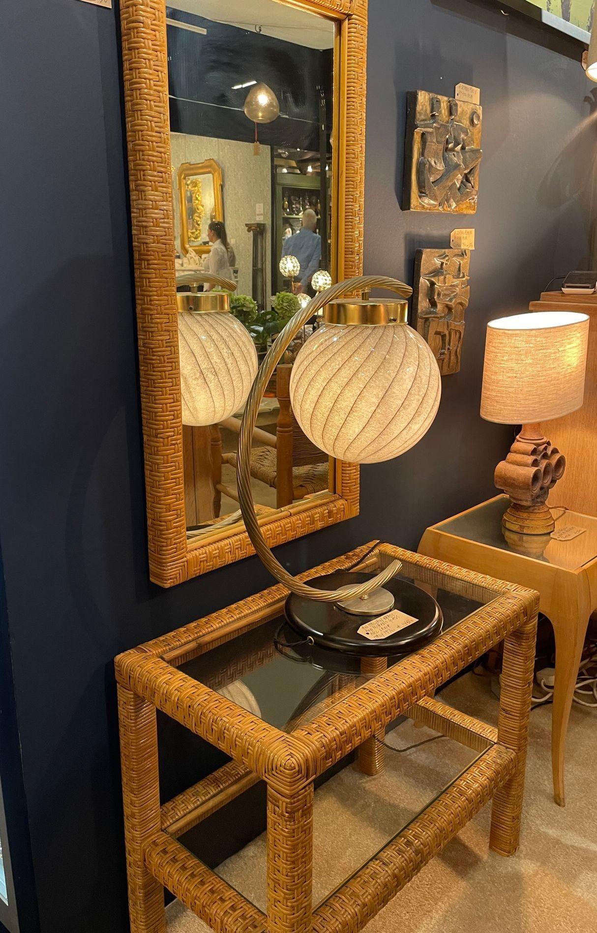 A 1970s Italian woven rattan mirror with matching console table with two glass shelves. Dimensions: Mirror 100cm x 51cm x 4.5cm Console 70cm wide x 39cm deep x 57cm high