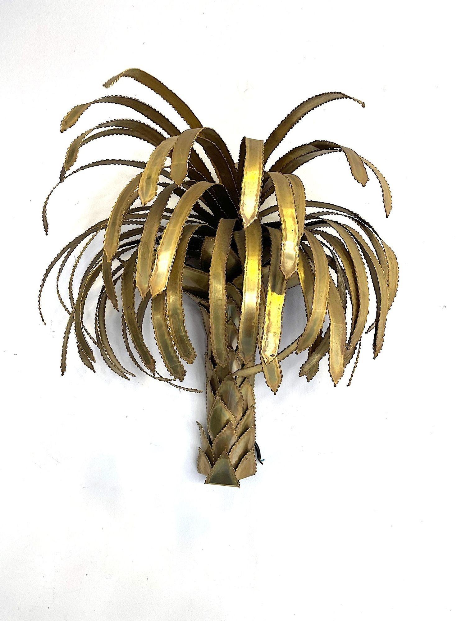 A 1970s Maison Jansen torch cut brass palm tree wall light with two light fitting under the fronds. Re wired with new brass fittings and PAT tested 