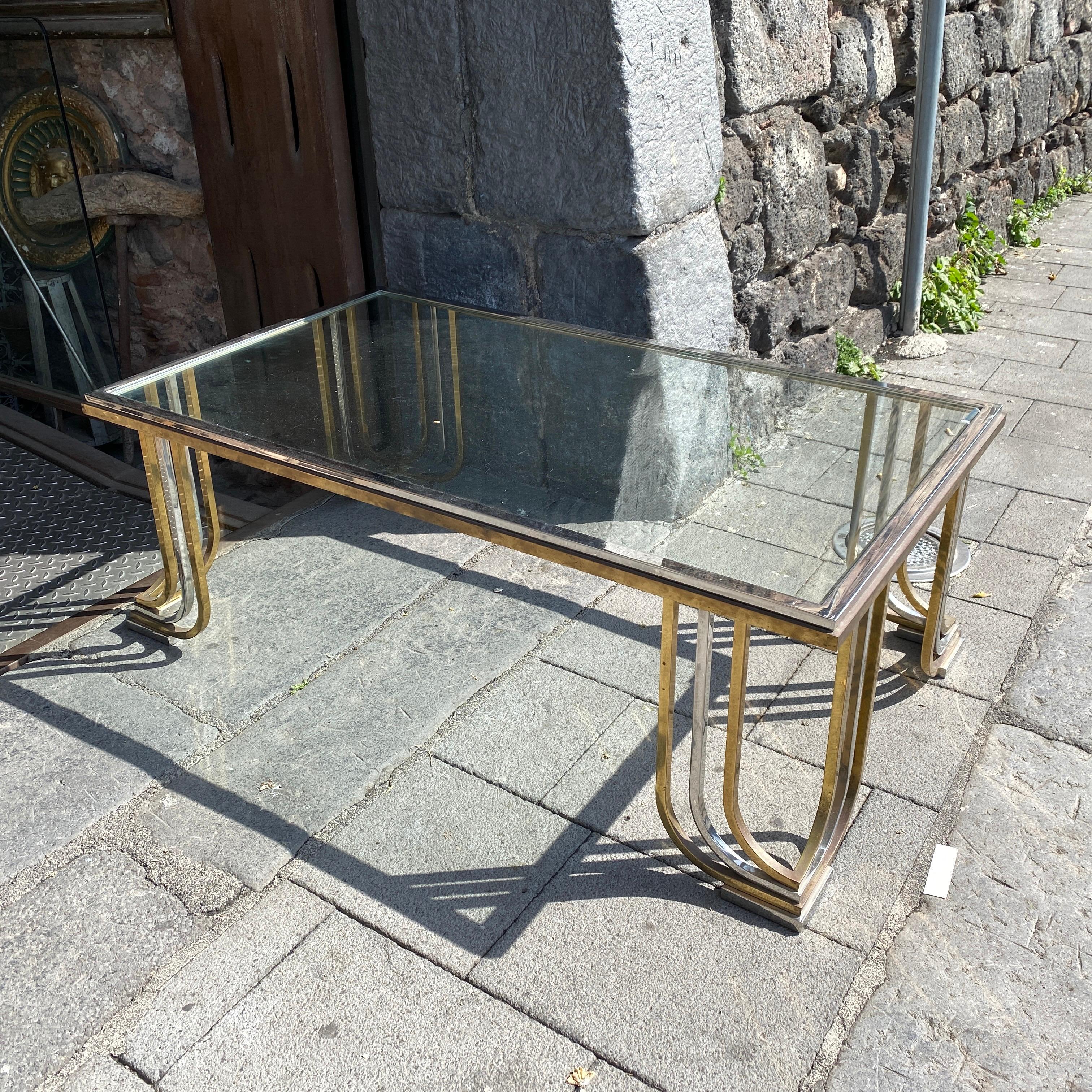 An Italian coffee table designed and manufactured in the 1970s by famous maker Banci Firenze, very good conditions, brass is in original patina, chromed metal in very good conditions. Only a small chip on the glass visible in the last photo.