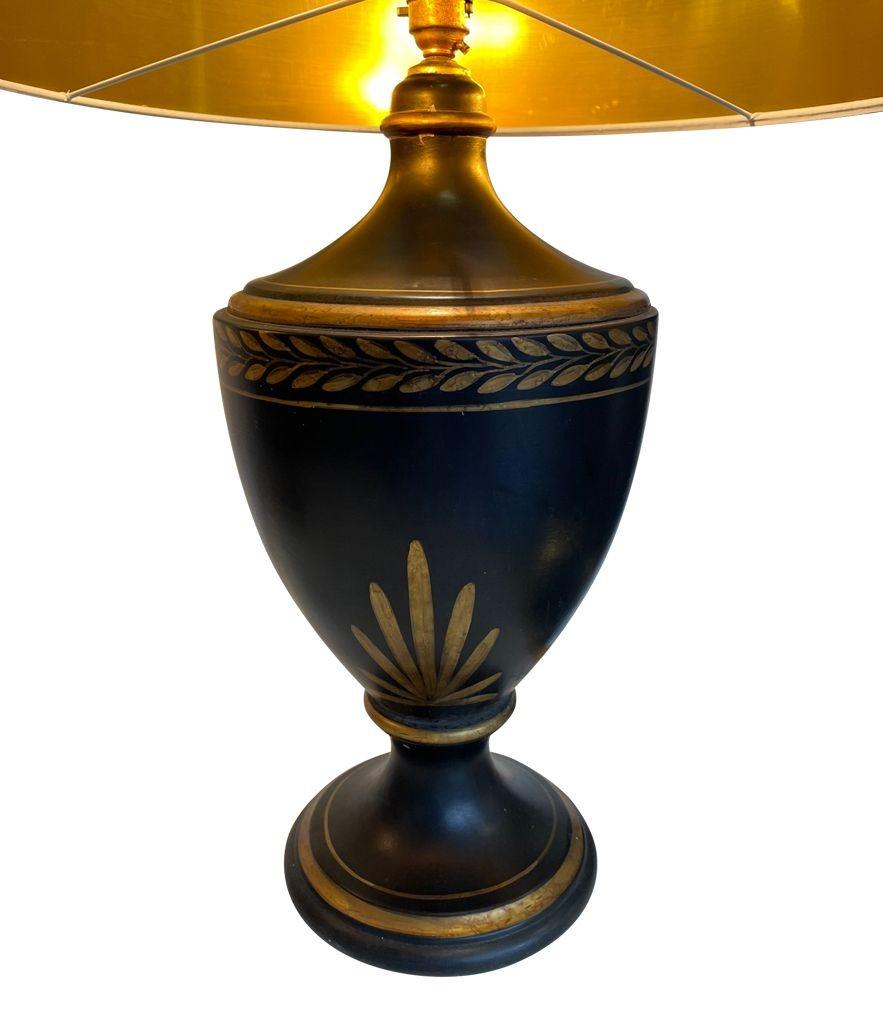 A 1970s pair of large French black ceramic gilt painted lamps in a Classical Greek style style with modern shades.