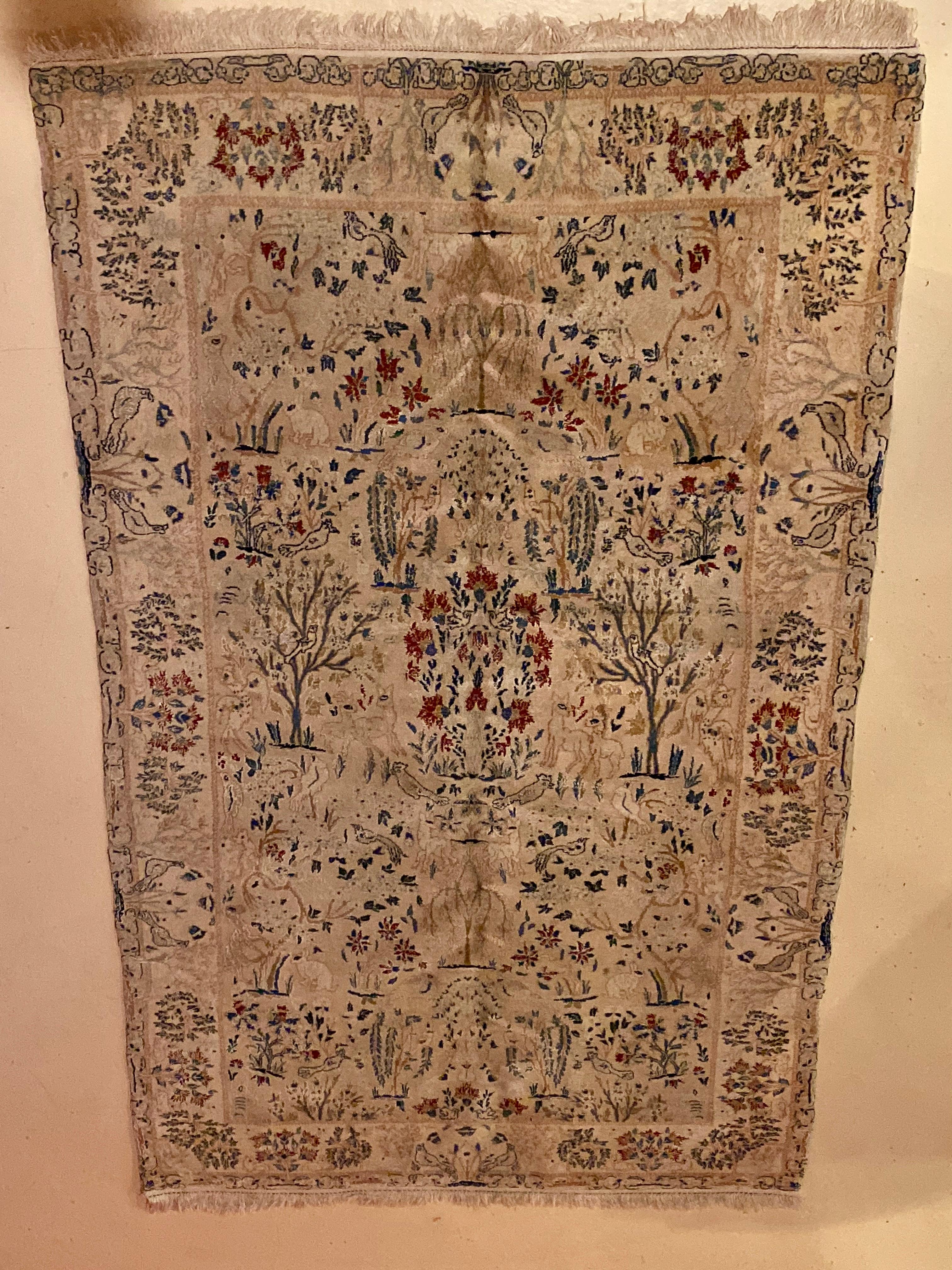A 1970s Pakistani wool handwoven carpet having a very tightly woven loom with birds, rabbits, trees and deer in a forest. A fine example of an oriental carpet that has been spun with love.