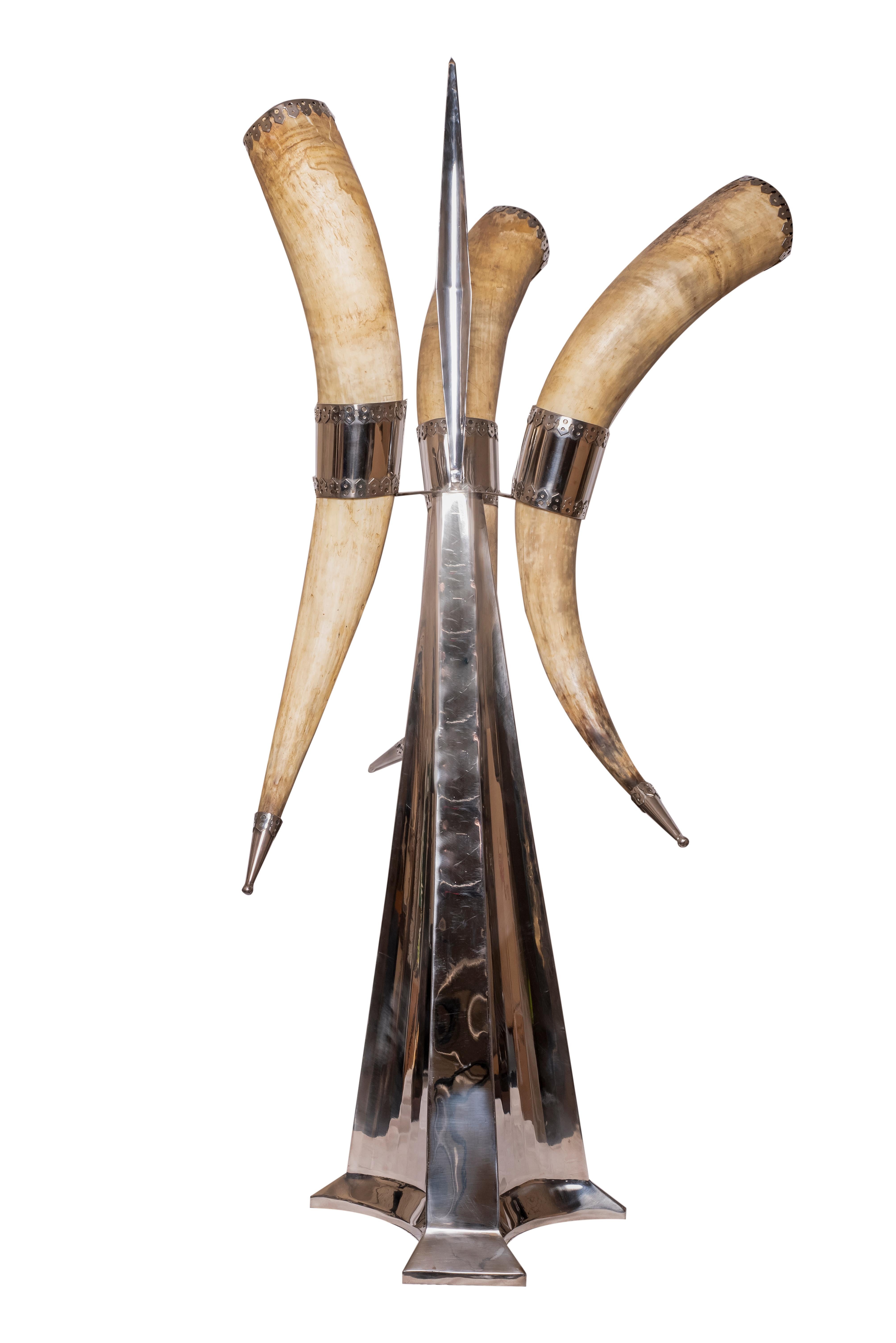 A 1970s grand sculpture by Anthony J. Redmile.
Three mounted grand horns on a stainless steel sculptural base. With plated metal ornamentation on the top and bottom of the horns.
