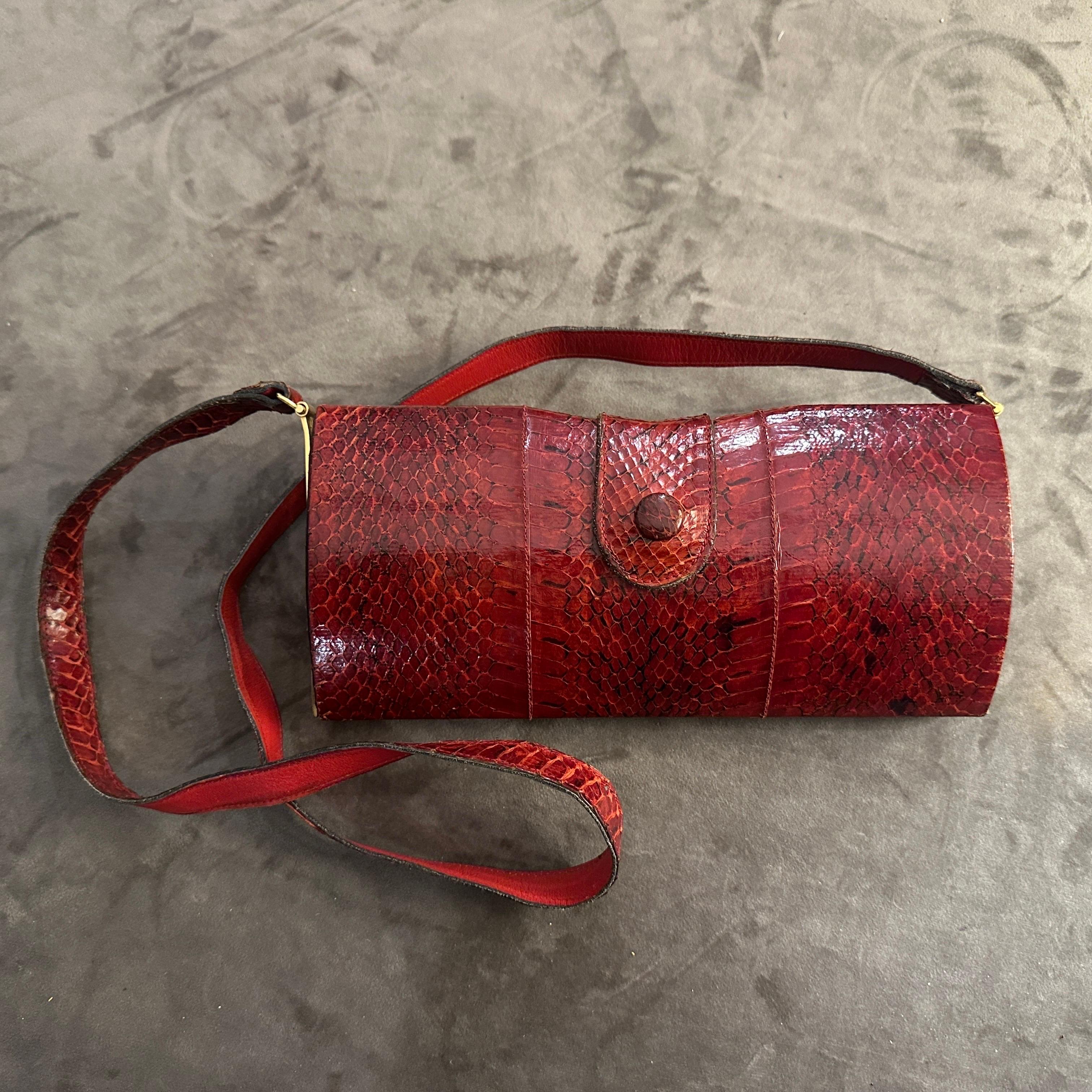 Step into the world of retro glamour with this stunning Vintage Textured Red Leather Shoulder Bag, crafted in the late 1970s to early 1980s. This bag exudes sophistication with its rich, deep red hue and a striking textured finish that catches the