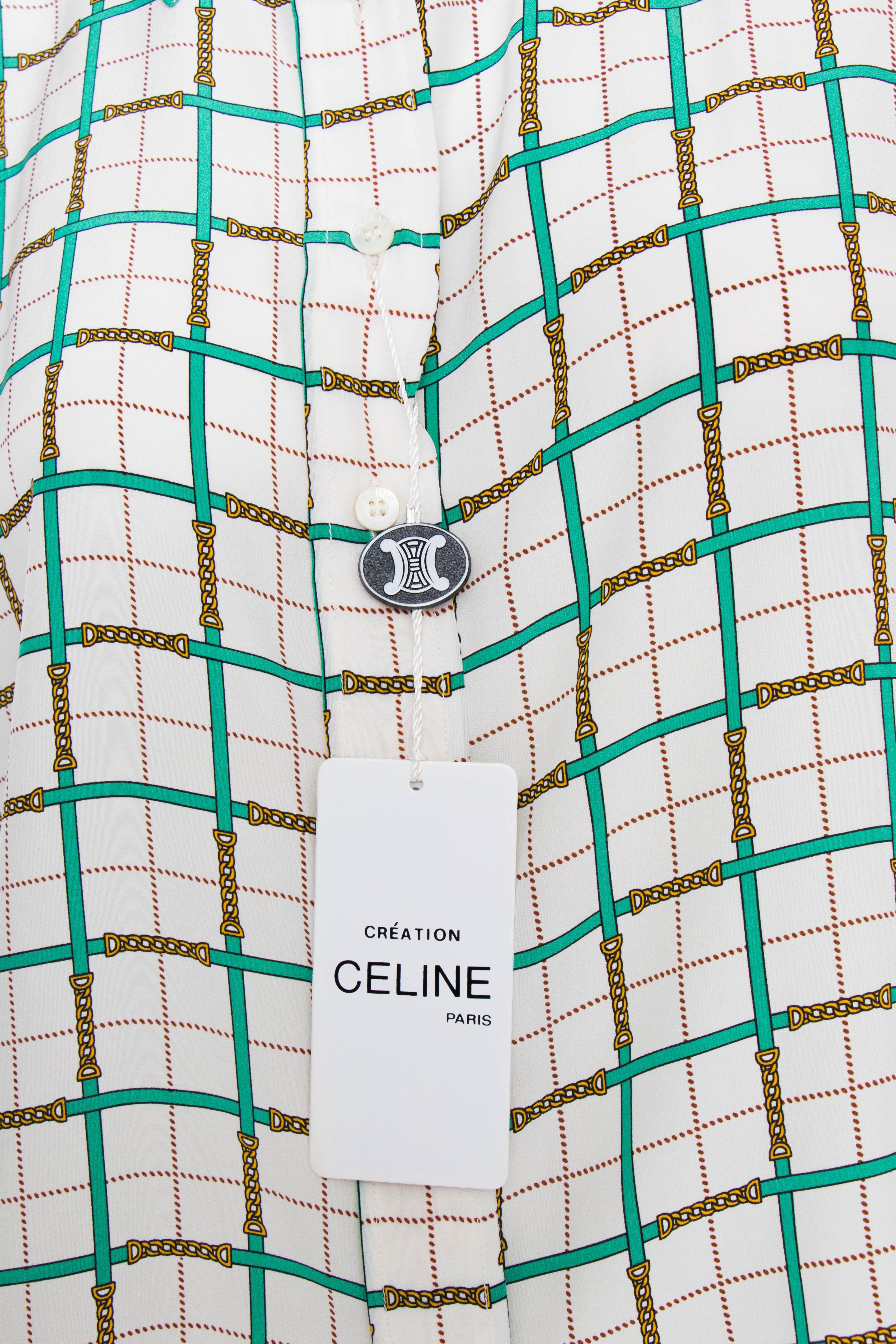 A 1970s Celine white silk blouse with a classic button-down front and the characteristic chain print in green and yellow. 

The size of the garment corresponds to a modern size small, but please note the measurements below to ensure the right fit.