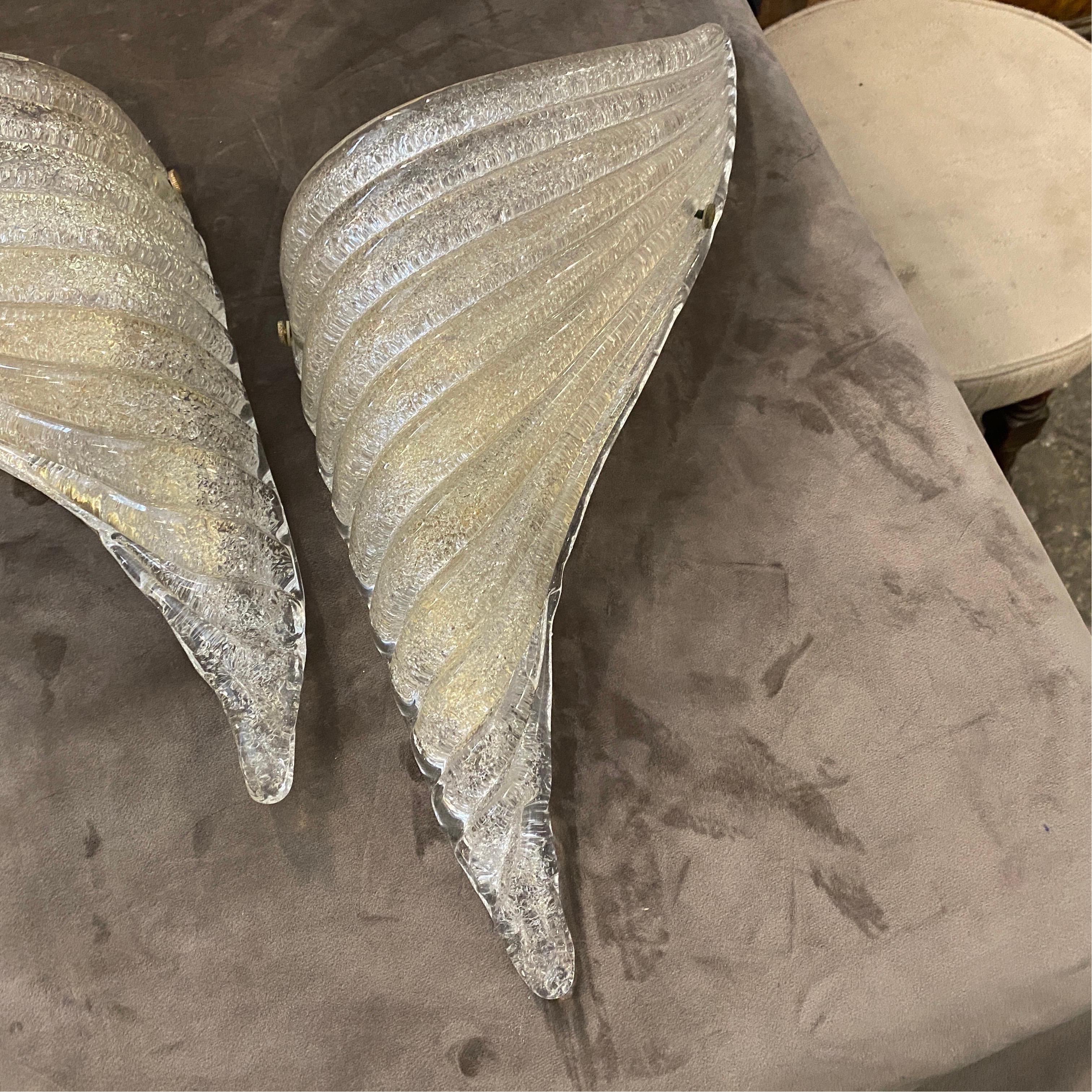 Two left and right wings wall sconces by Vistosi. Transparent and gold inside murano glass are in perfect conditions. they work 110-240 volts and need regular e14 bulbs.