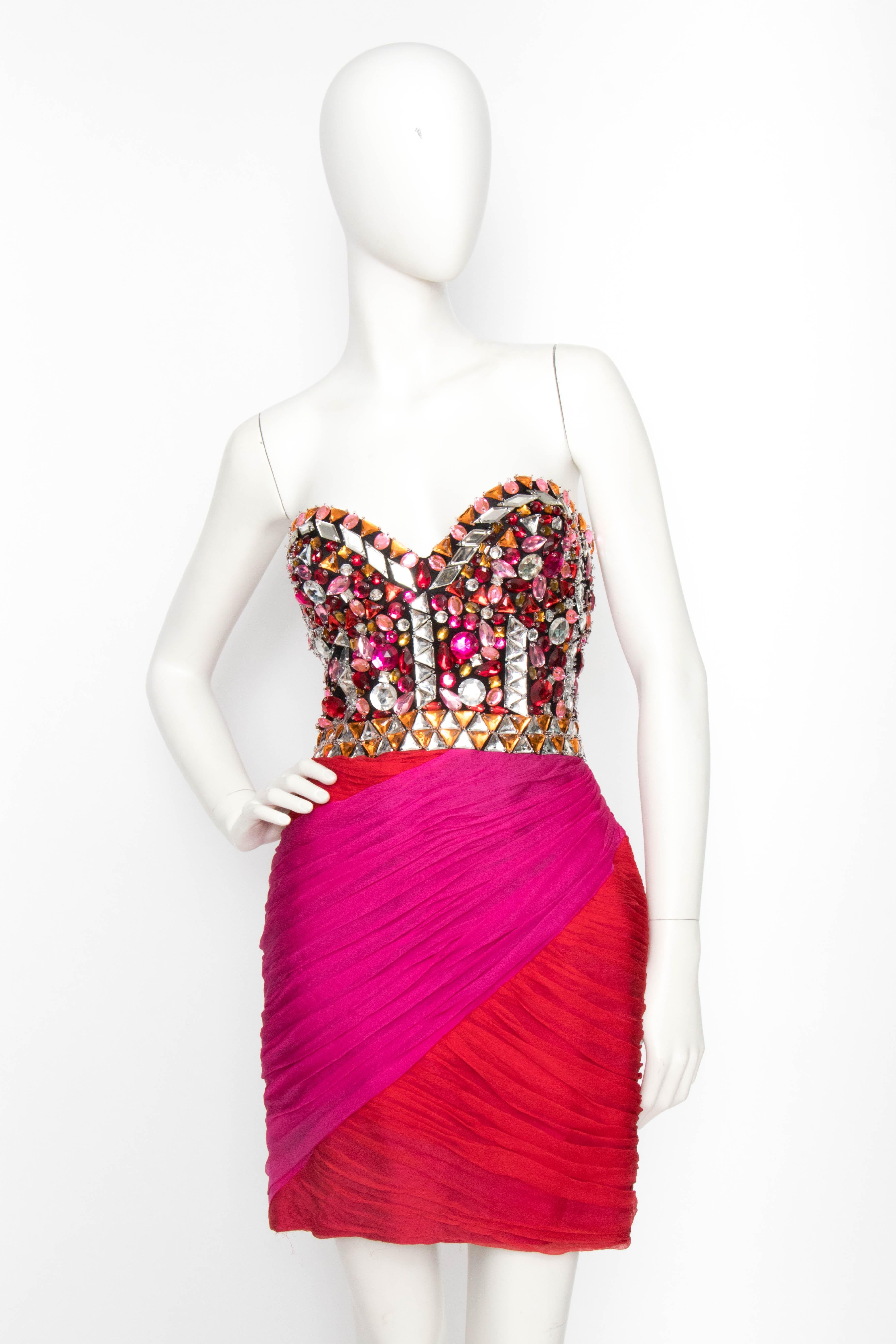 An incredibly glamorous 1980s Loris Azzaro pink and red silk chiffon cocktail dress with a ruched mini-skirt and bejewelled bustier. The dress comes with a chiffon shawl in matching red and pink with a rhinestone setting in the center. The dress is