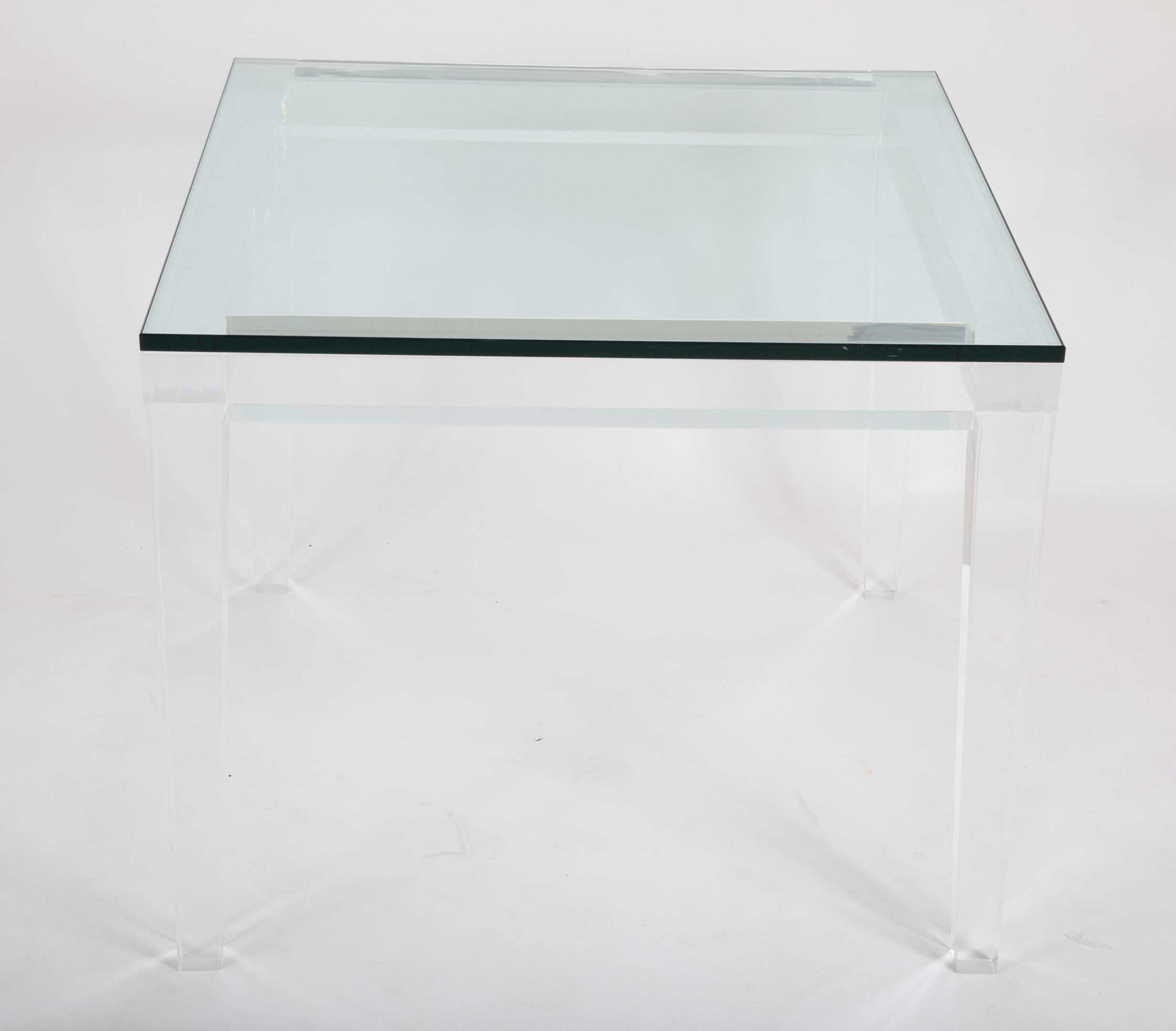 An exceptionally heavy and well made Lucite games table with glass top. In the manner of Karl Springer.
