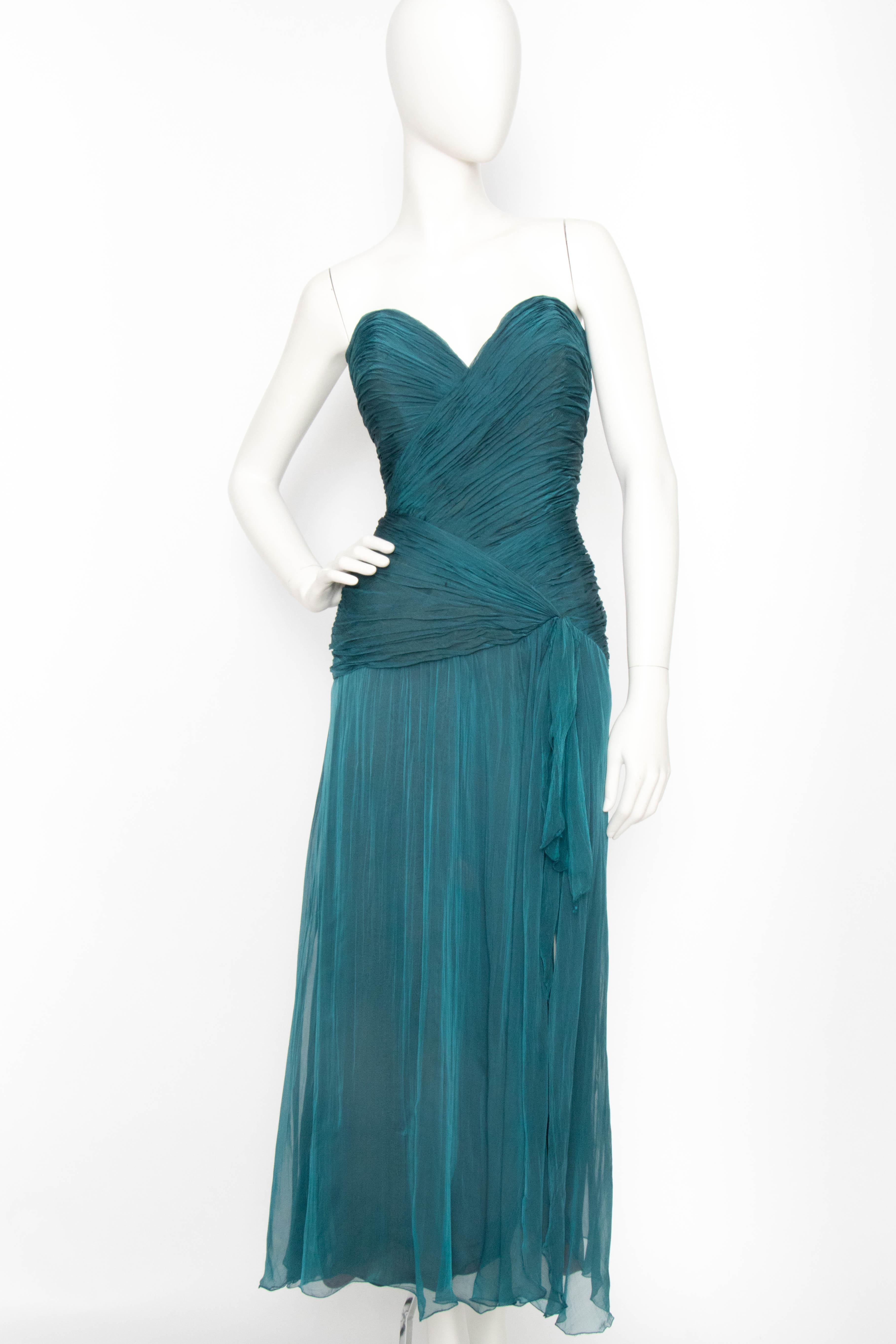 An incredible 1980s Azzaro blue silk chiffon dress with a sweetheart neckline, ruched bodice and semi-sheer skirt with a fabulous thigh gracing slit detail in front. The dress has a back zipper closure with a hook and eye fastening at the top, and a