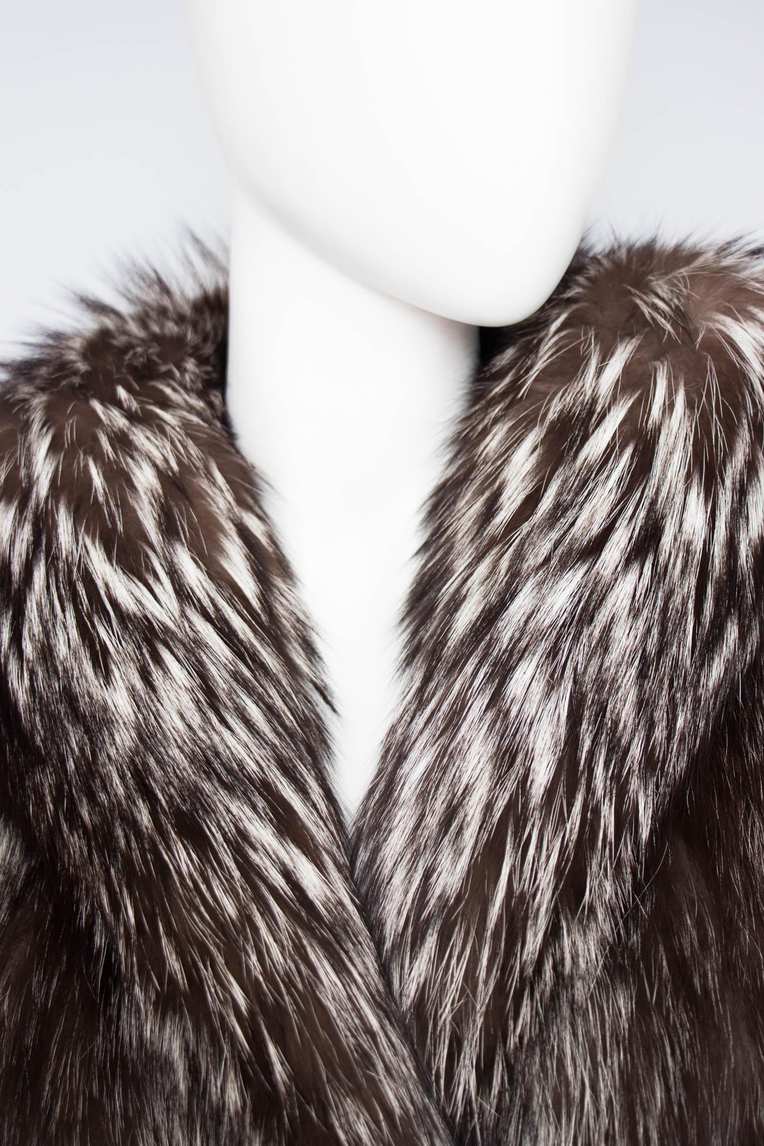 An incredibly glamorous 1980s luscious grey Saga fox fur coat with big puffy shoulders and sleeves. The fabulous fur has a front closure, side pockets and is fully lined. 

The size of the item corresponds to a modern size small, but please note the