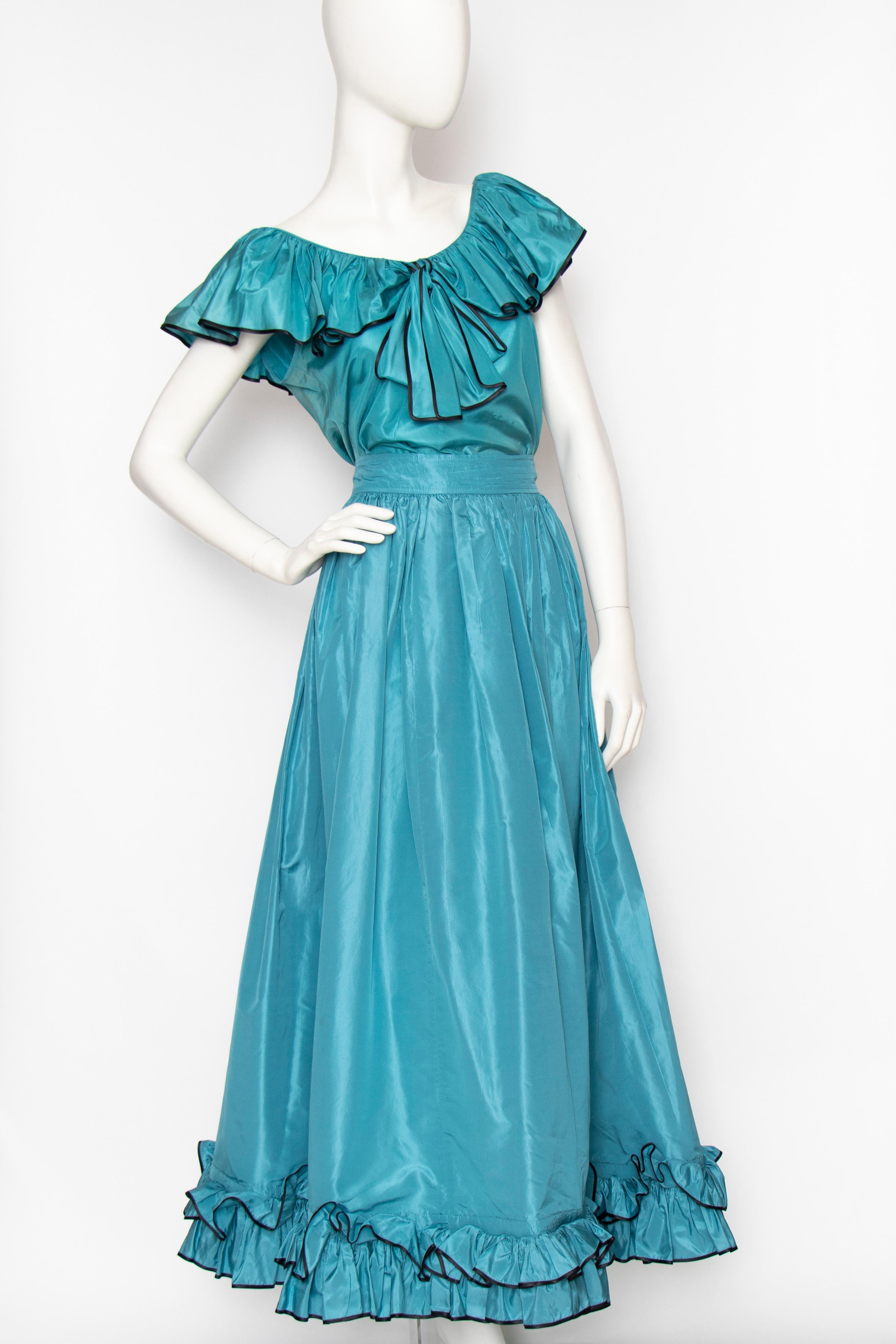 An incredible 1980s Yves Saint Laurent luscious turquoise silk taffeta two-piece dress consisting of a wide a-line skirt and sleeveless top. Both items have a ruffle detail, the skirt at the hem and the blouse at the collar complete with bow detail.