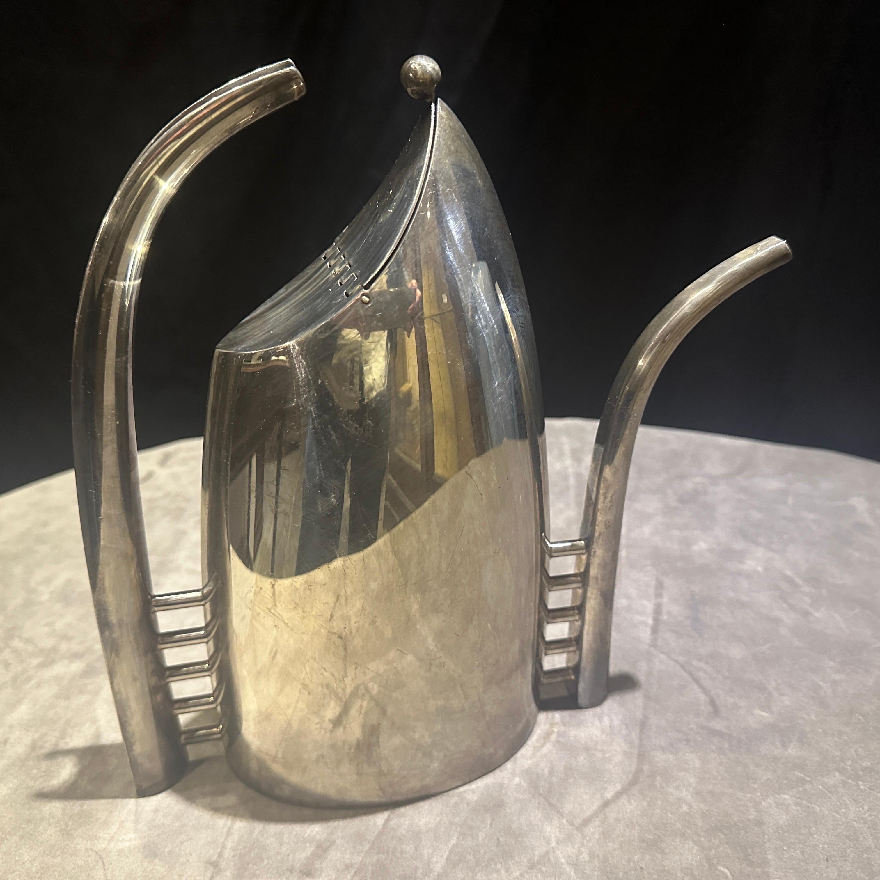 This is a striking and collectible 1989 Minimalist Silver Plated Coffee Pot, a renowned piece designed by the esteemed Italian silversmith Lino Sabattini. The pot is marked 