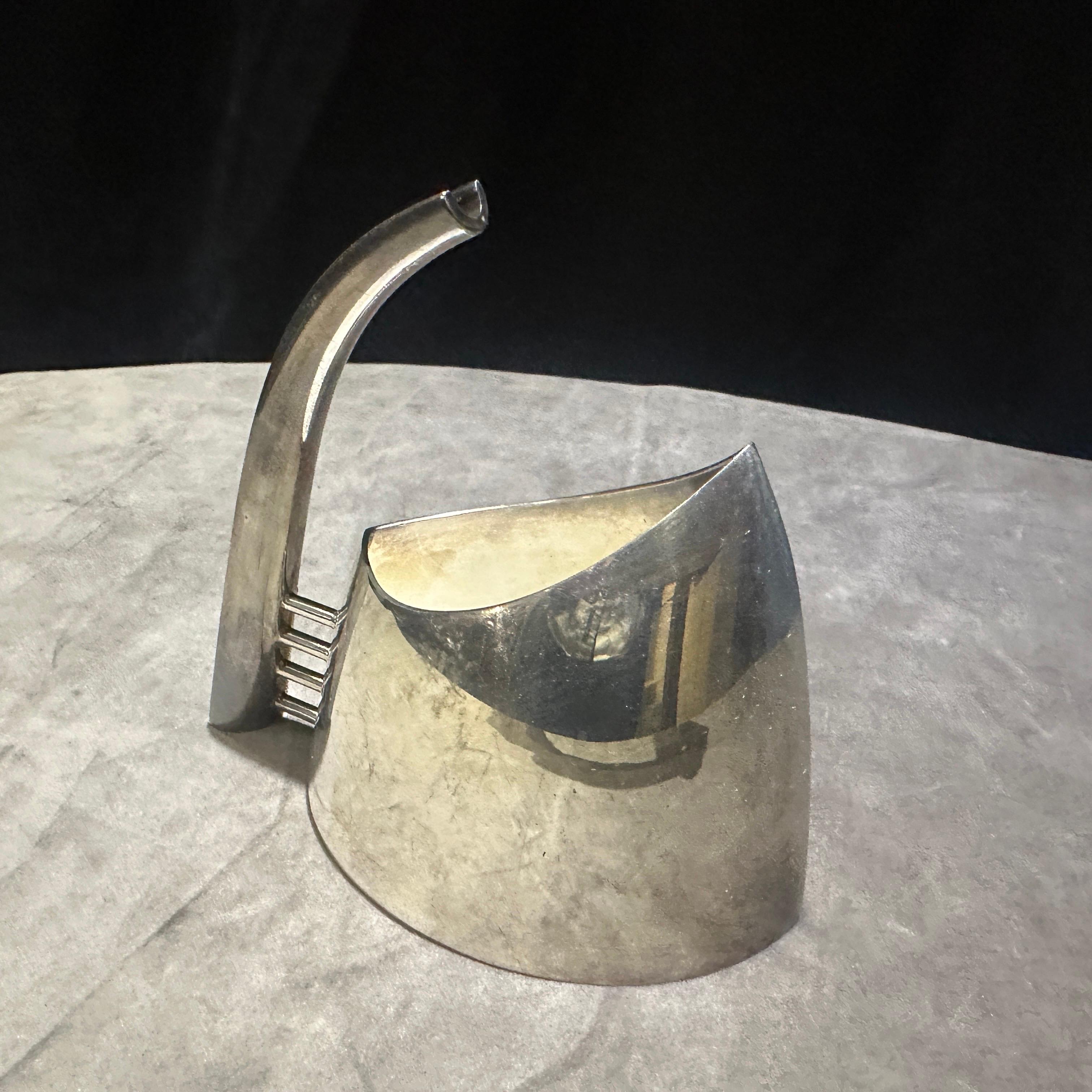 This is a striking and collectible 1989 Minimalist Silver Plated Milk Jug, a renowned piece designed by the esteemed Italian silversmith Lino Sabattini. The Milk Jug is marked Sabattini argenteria confirming its authenticity and provenance. Its