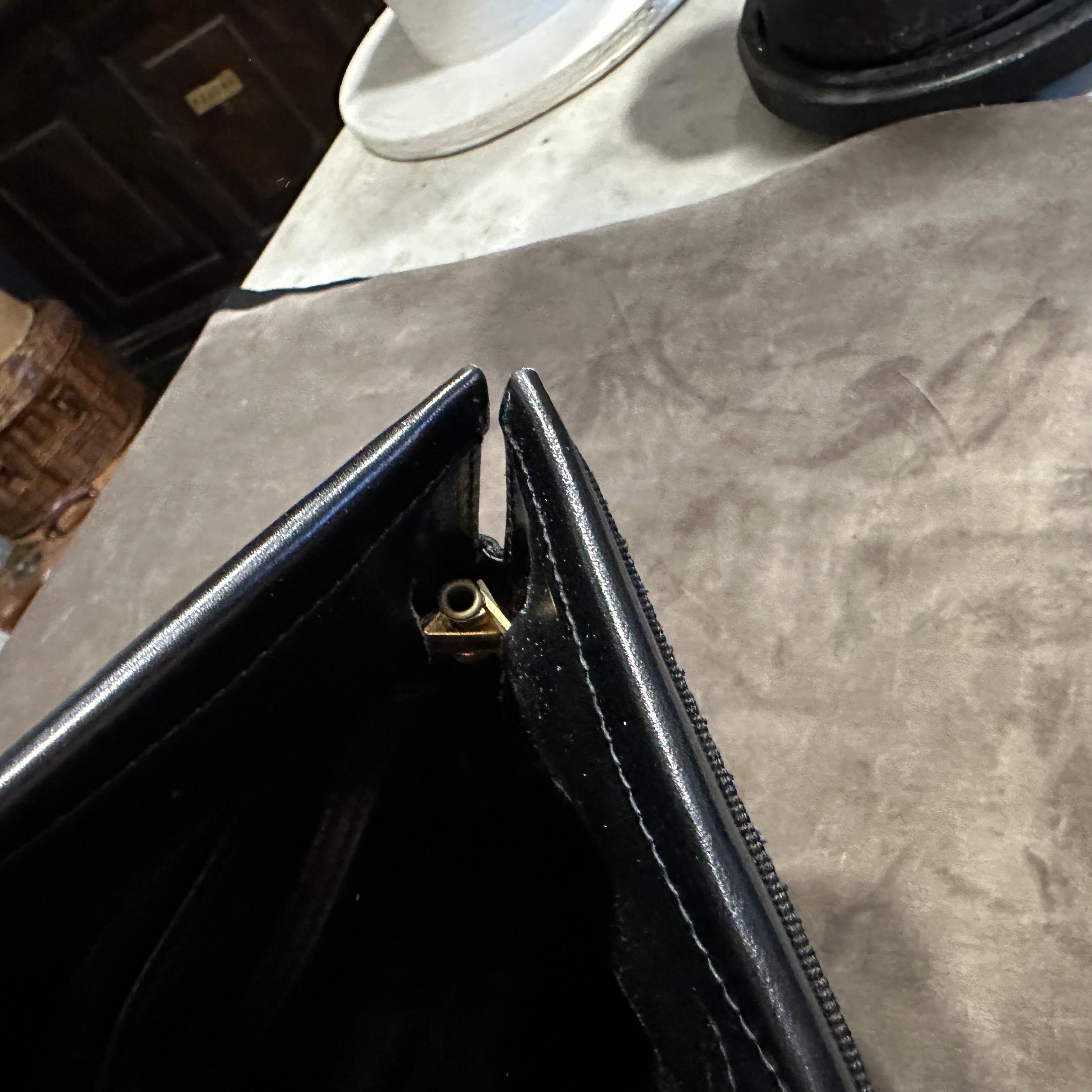 A 1990s Black Leather and Brass Shoulder Bag by Salvatore Ferragamo For Sale 1