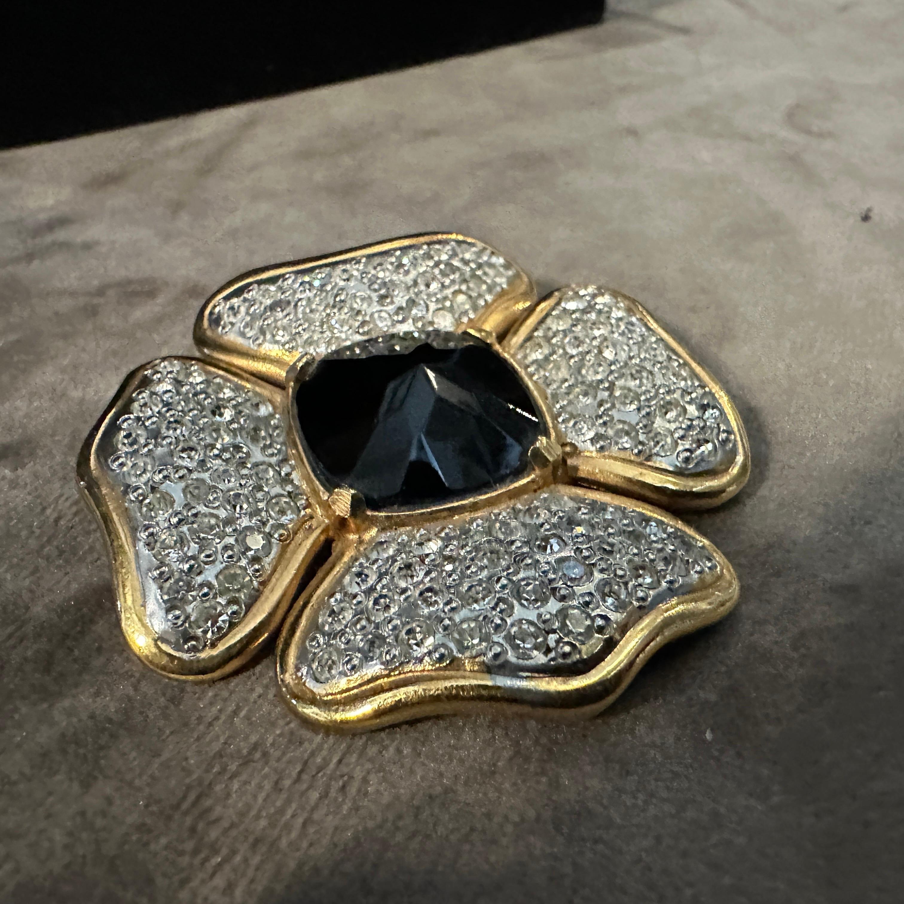 This is a 1990s Valentino Garavani flower brooch, a striking piece of costume jewelry showcasing the luxury and sophistication associated with the Valentino brand. The brooch is designed in the shape of a flower, featuring a large, faceted black