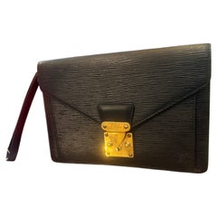 A 1995 Louis Vuitton Poche Dragonne Blak Epi Leather Clutch