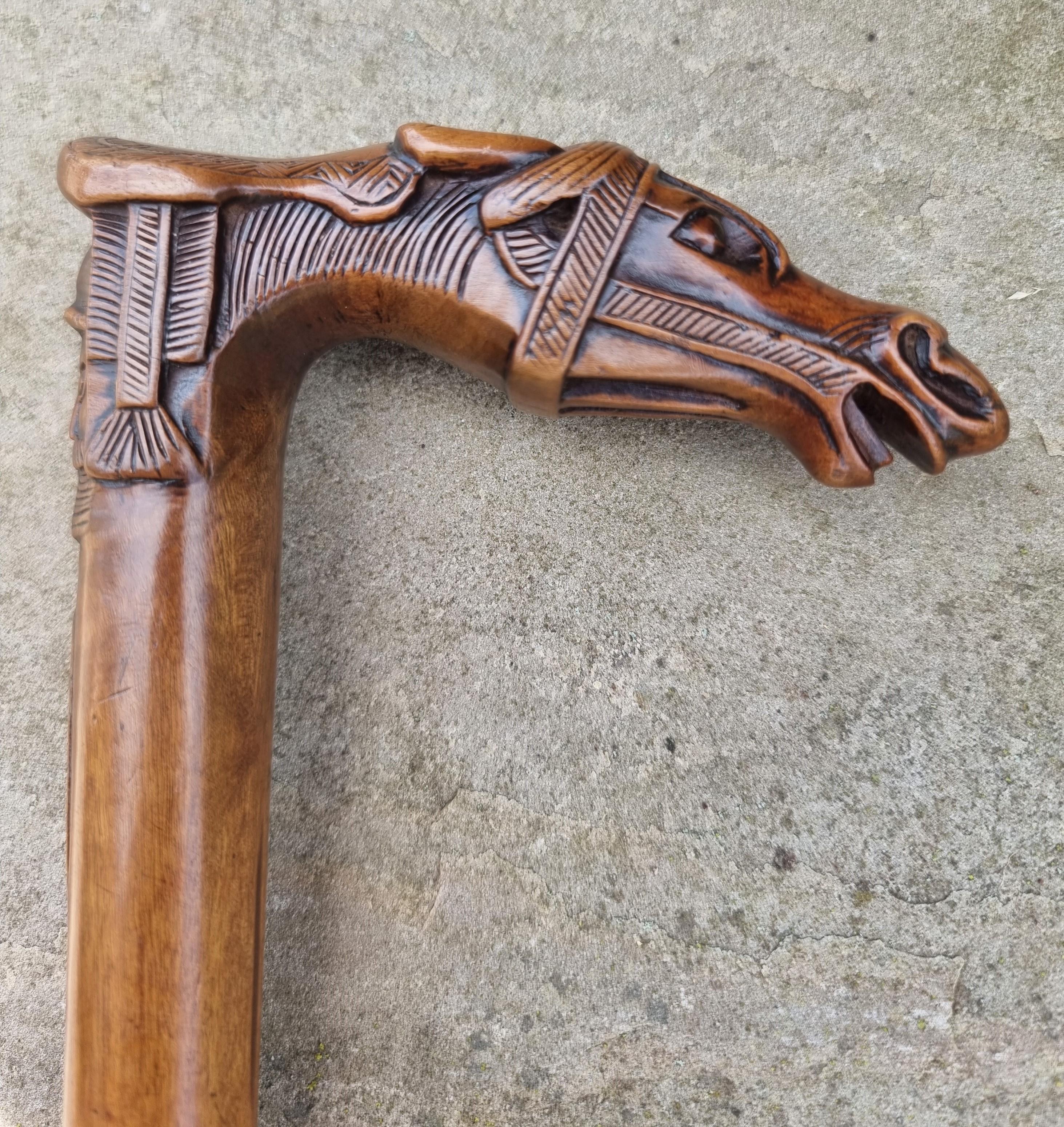 This superb antique carved solid olive wood walking stick is made from one single piece of wood.

It is a Grand Tour item made on the Greek island of Corfu from the town of Kepkypa where such pieces were handmade and sold to wealthy 19th century