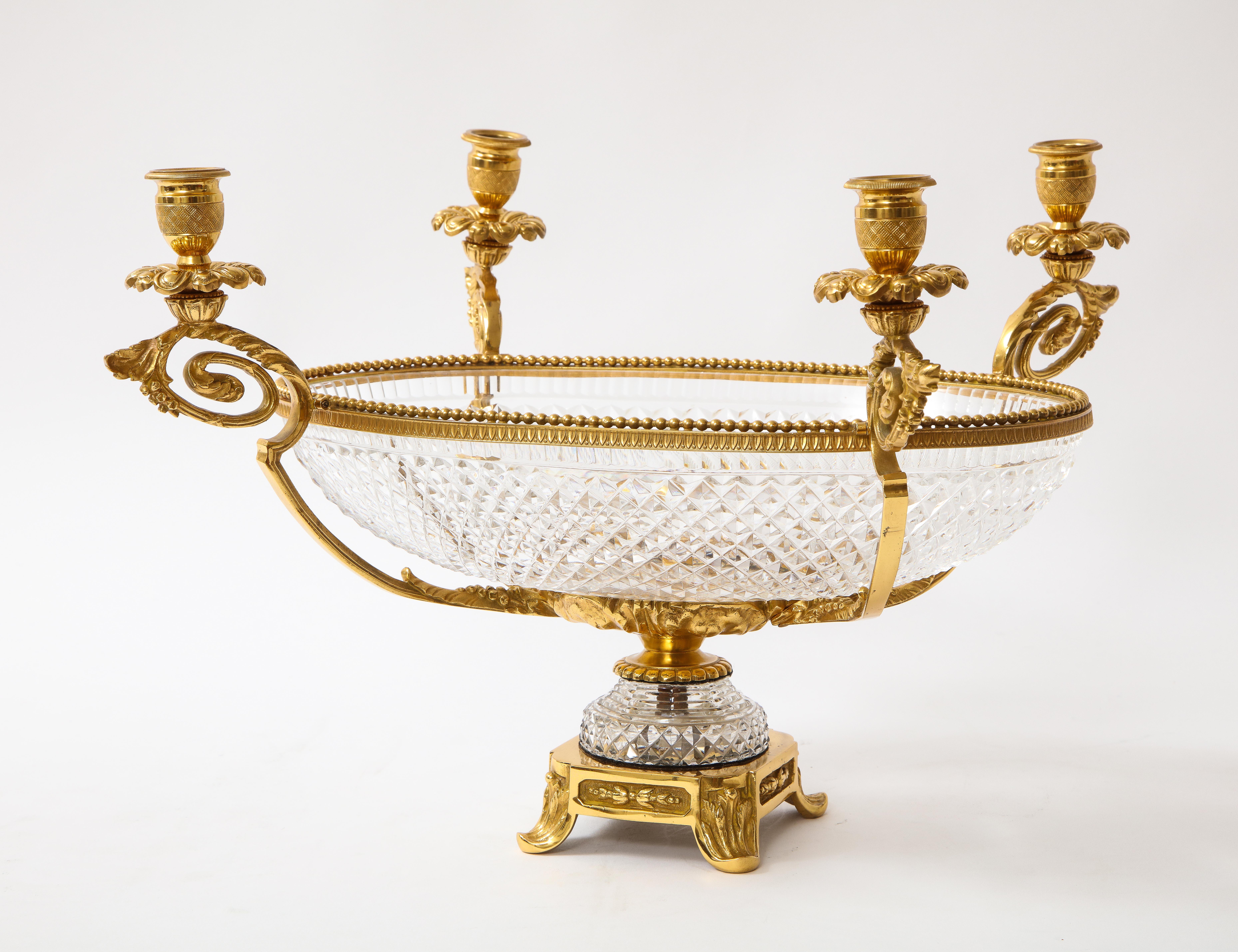 An unusual 19th century French Baccarat Prismic pattern crystal centerpiece and four-light dore bronze candelabra set. The centerpiece bowl is French Baccarat crystal, the finest crystal manufacturer in the world. The outside of the bowl is