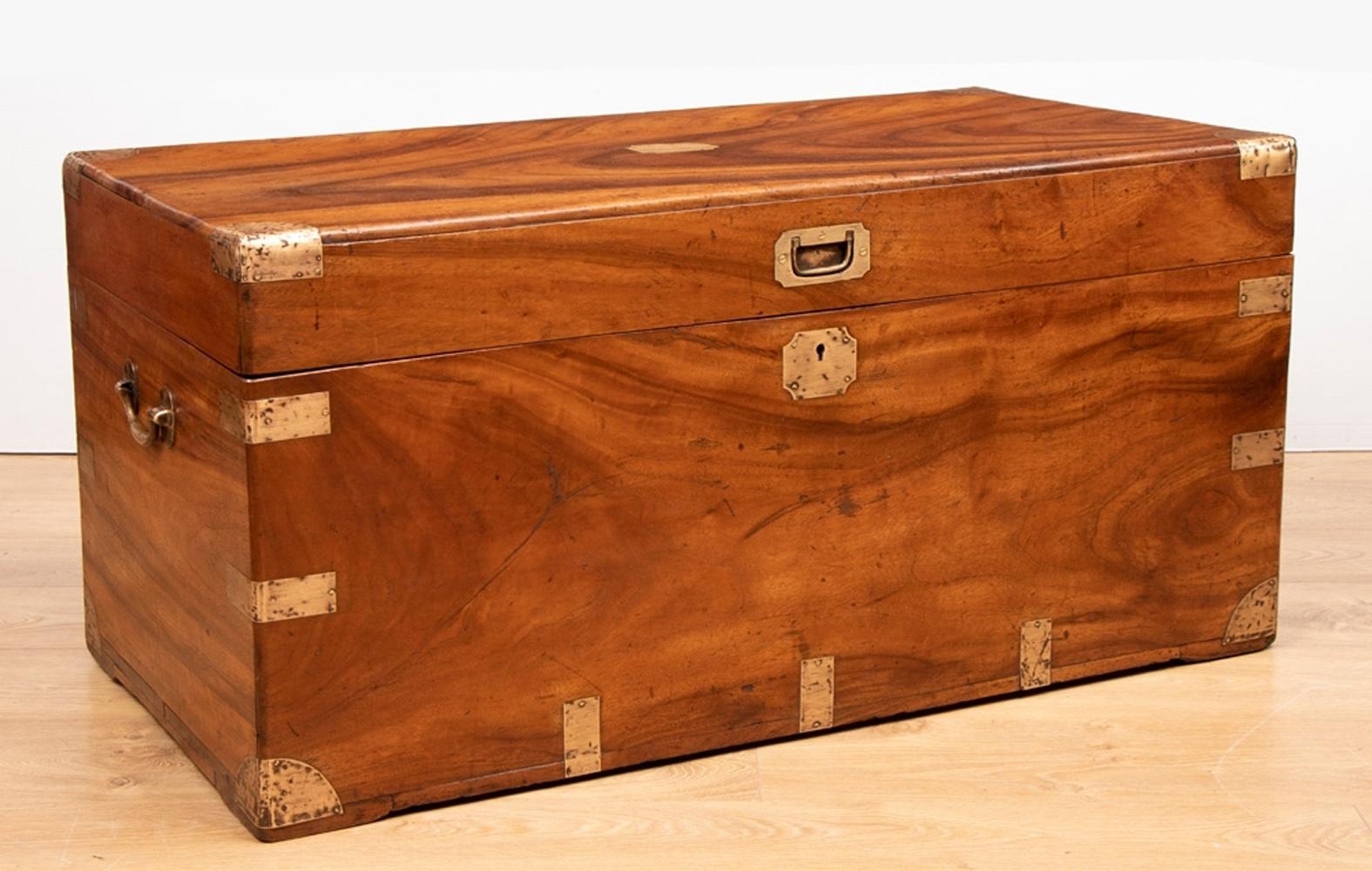 This is a very good example of the classic original Camphor wood military campaign chest. We have sympathetically restored the chest and polished the trunk to restore that warm honey color we all love.

This chest has a lovely swirling example of