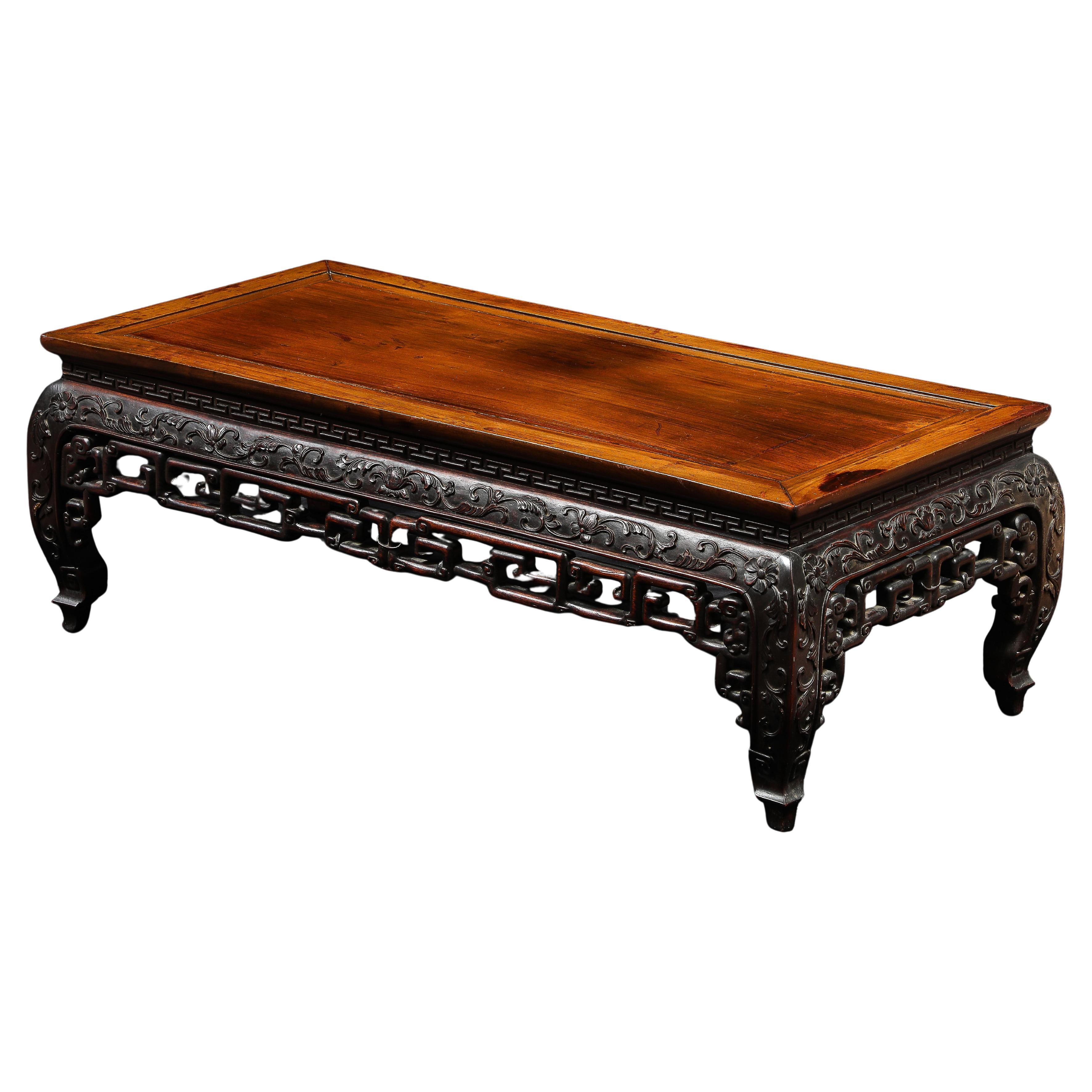 A 19th C. Chinese Carved Hardwood Low Table with Relief Designs, possibly Zitan