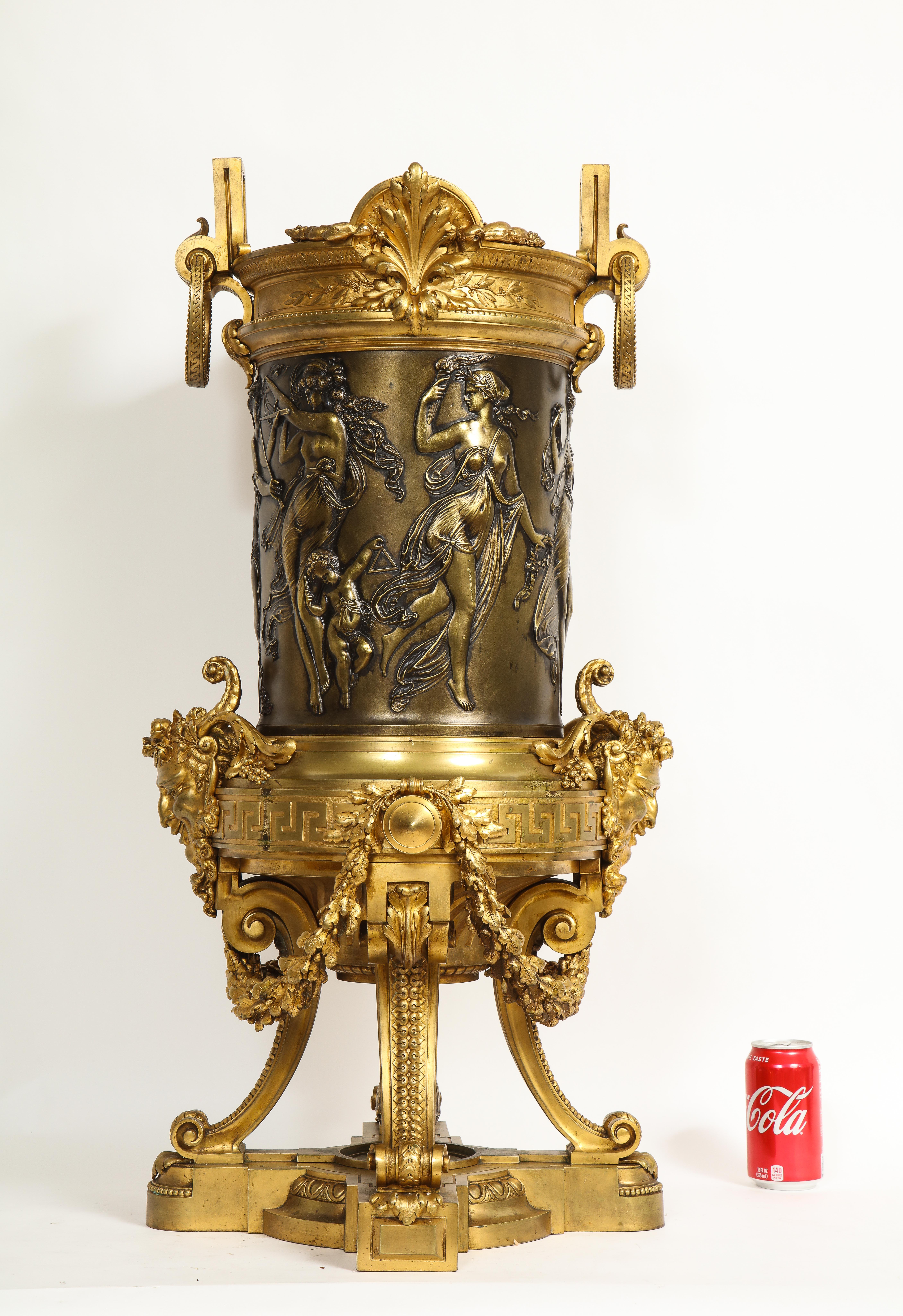 A Magnificent and Large 19th Century French Louis XVI Style Patinated and Doré Bronze Jardinière/Planter, Attributed to F. Barbedienne  The large and imposing piece features a regal rim adorned with stylized ferns made of doré bronze, which are