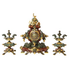 A 19th C. French Patinated Bronze & Ormolu Mounted Rouge Marble Clock Garniture