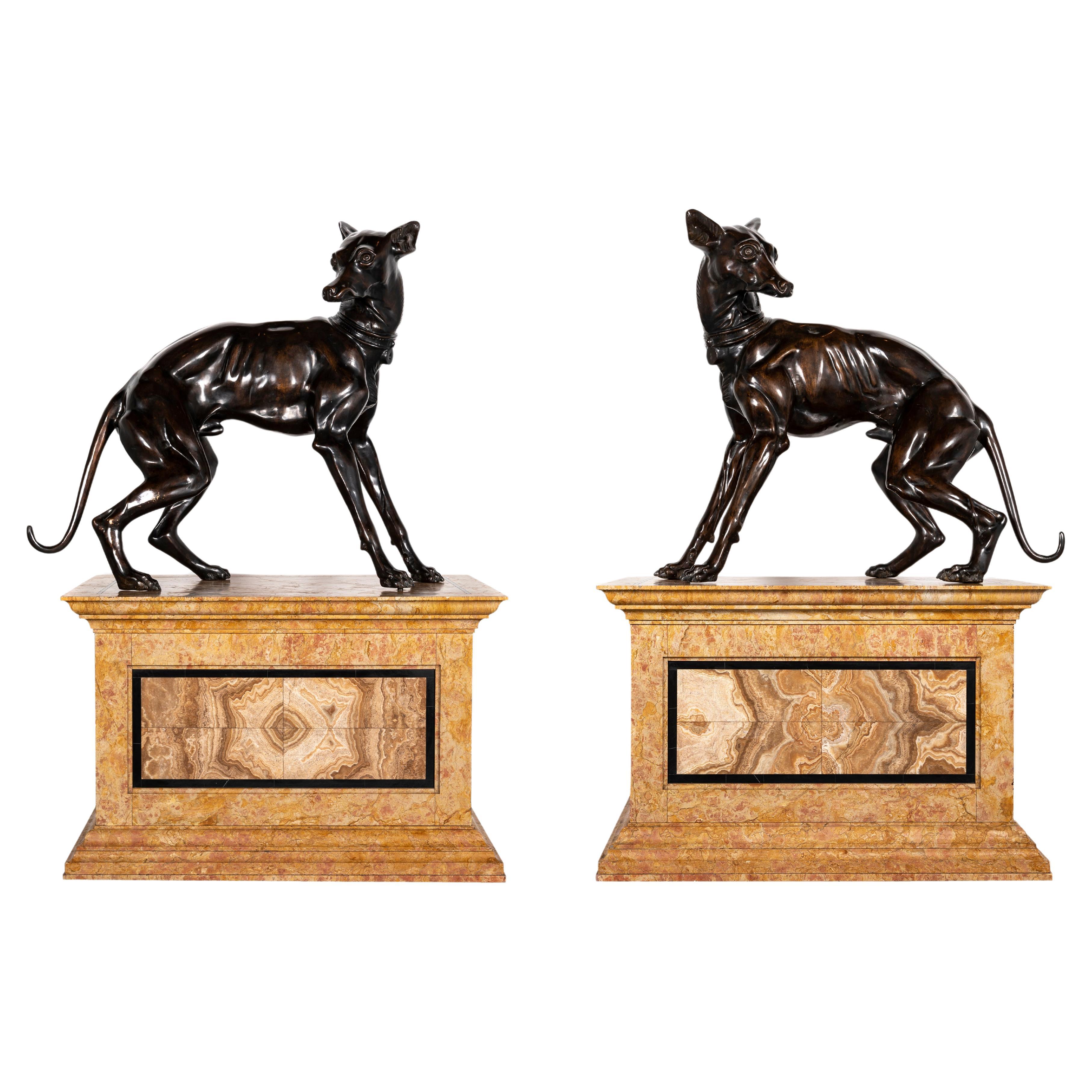 A.I.C. Coppia italiana di cani levrieri in bronzo patinato su basamenti in marmo a gradini